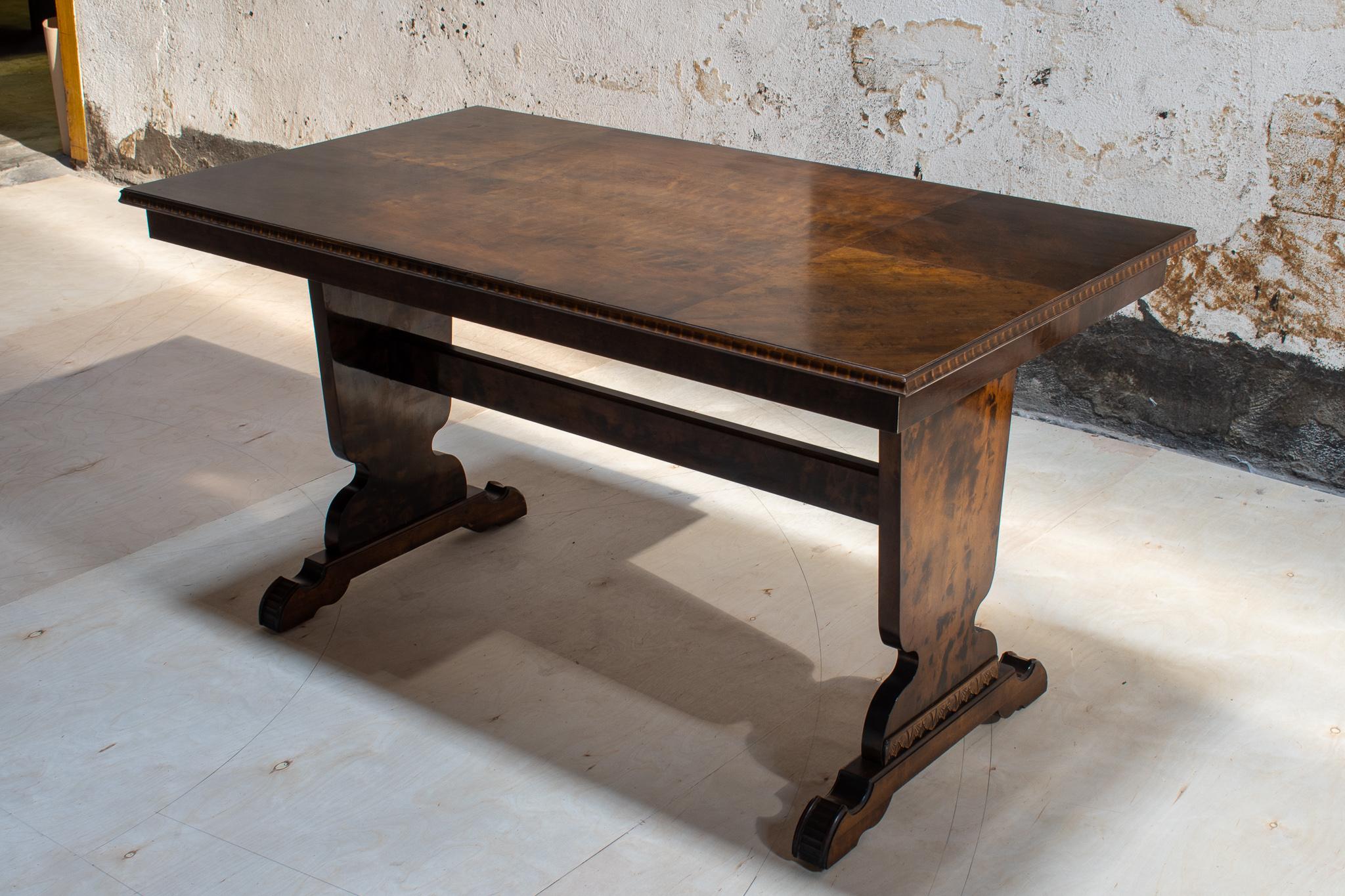 Swedish Art Deco trestle dining table made of dark flame birch with carved edge and feet. This style of trestle dining table is referred to as a 