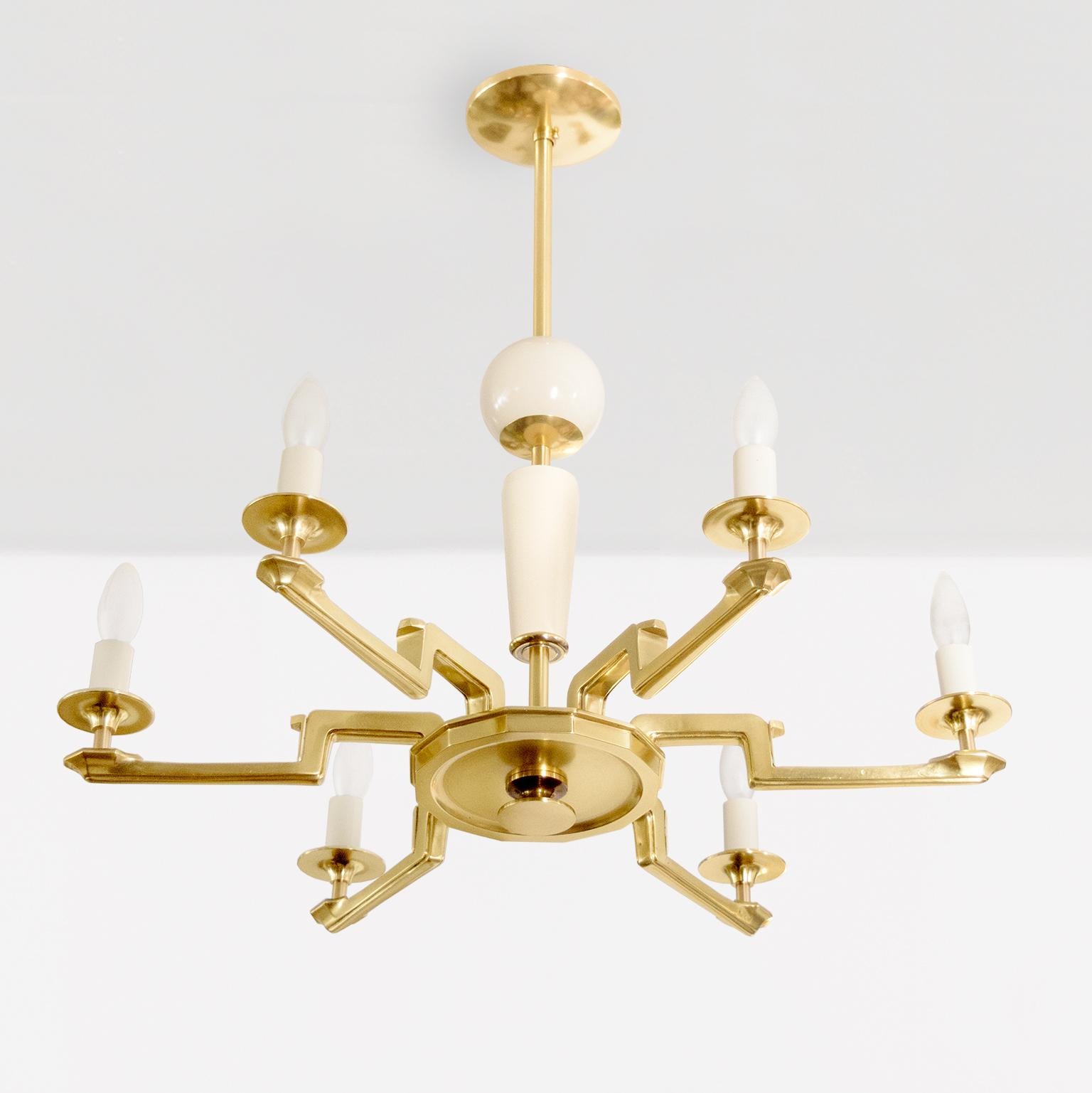 Swedish Art Deco 6-arm chandelier with details in ivory colored lacquer emanating from a hexagonal center body. Each finely detail arm meanders outwards to a candelabra socket. The candle sleeves are ivory colored lacquer matching the solid wood