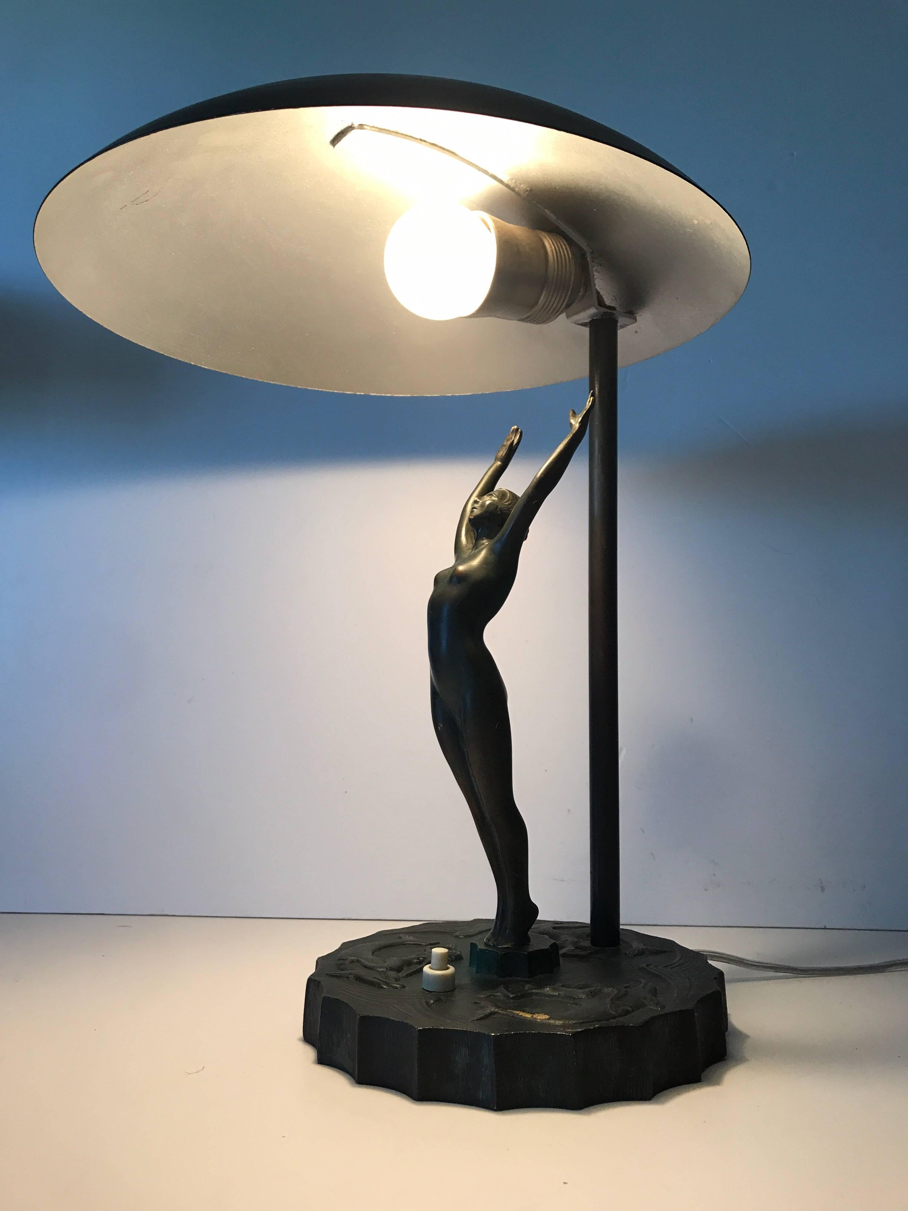 Rare Swedish Art Deco Bronze and Steel Table Lamp.
This lamp was most likely made at Herman Bergmans bronze casting factory. It has three dolfins and mermaids cast in relief to the base and the woman in solid bronze stretching up to the light. This