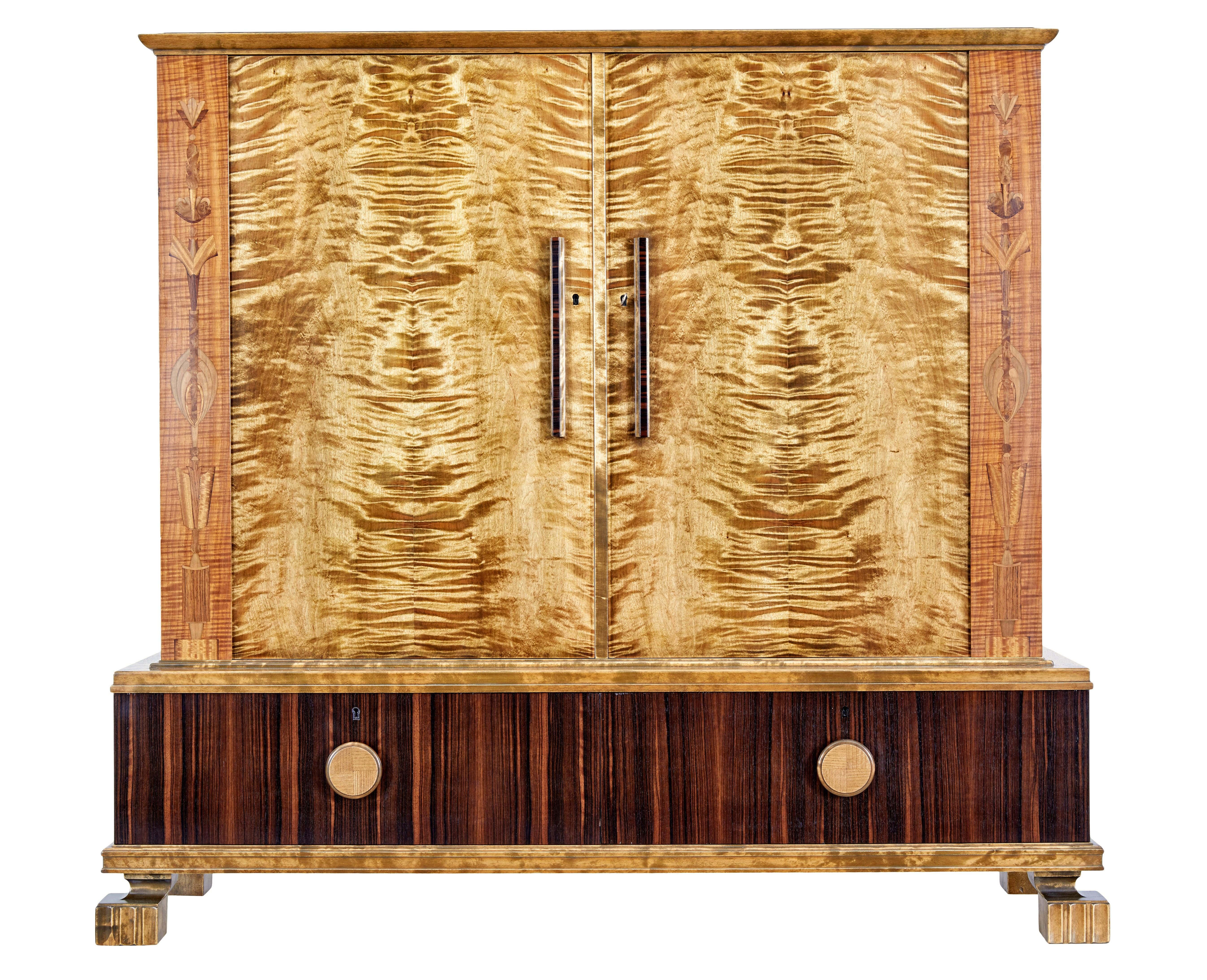 Swedish art deco burr birch cupboard circa 1930.

We are pleased to offer this stunning cabinet/sideboard which we have just re-finished in our workshop.

Beautifully presented in birch, mahogany and kingwood.  Slight over-sailing top stands above a