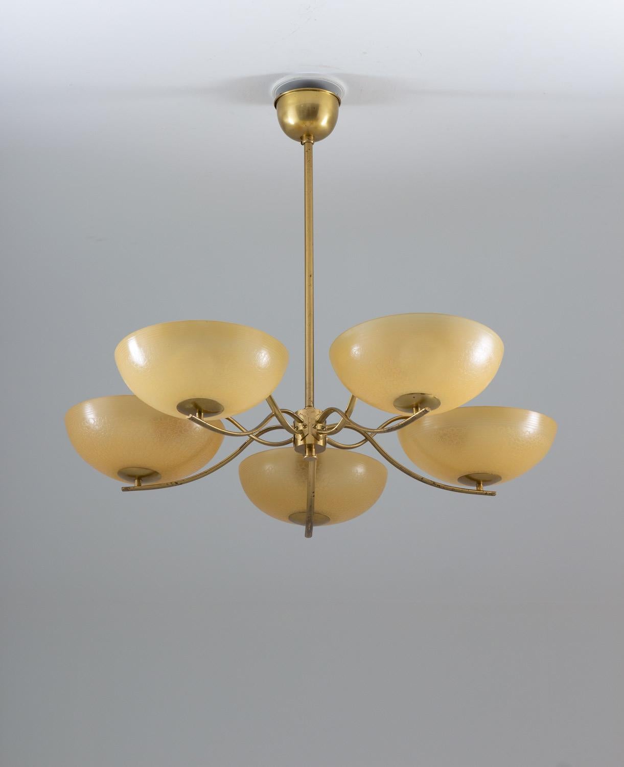 Art Deco chandelier in brass and glass, most likely produced in Sweden.
This great looking chandelier is made with a high sence of quality. The simple, elegant design makes it a great example of the art deco era. 
Each shade measures 23cm / 9in in