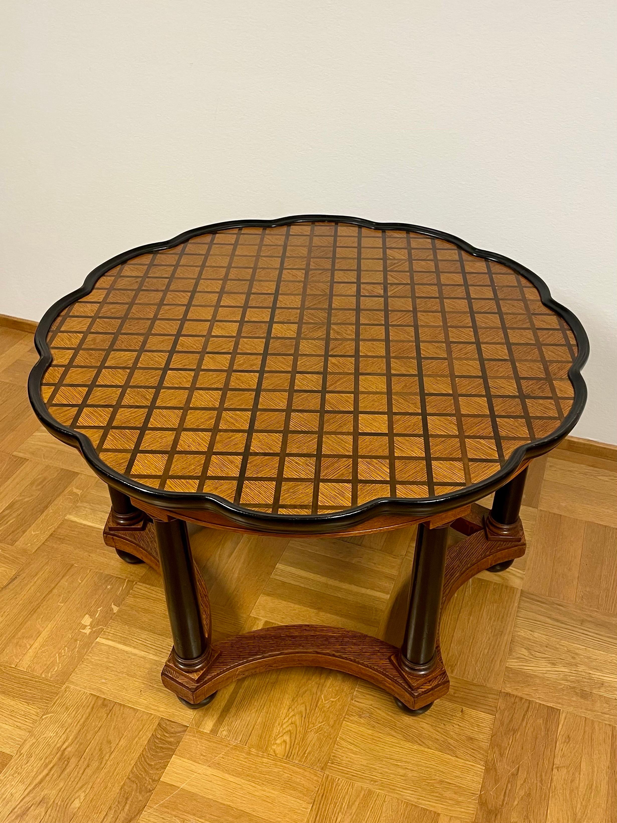 This is the Swedish Art Deco coffee table in the manner of David Blomberg, manager and designer at Nordiska Kompaniet in Stockholm.

It comes with a beautiful shiny dodecagonal, twelve sided, flower shaped table top with a squared pattern of birch,