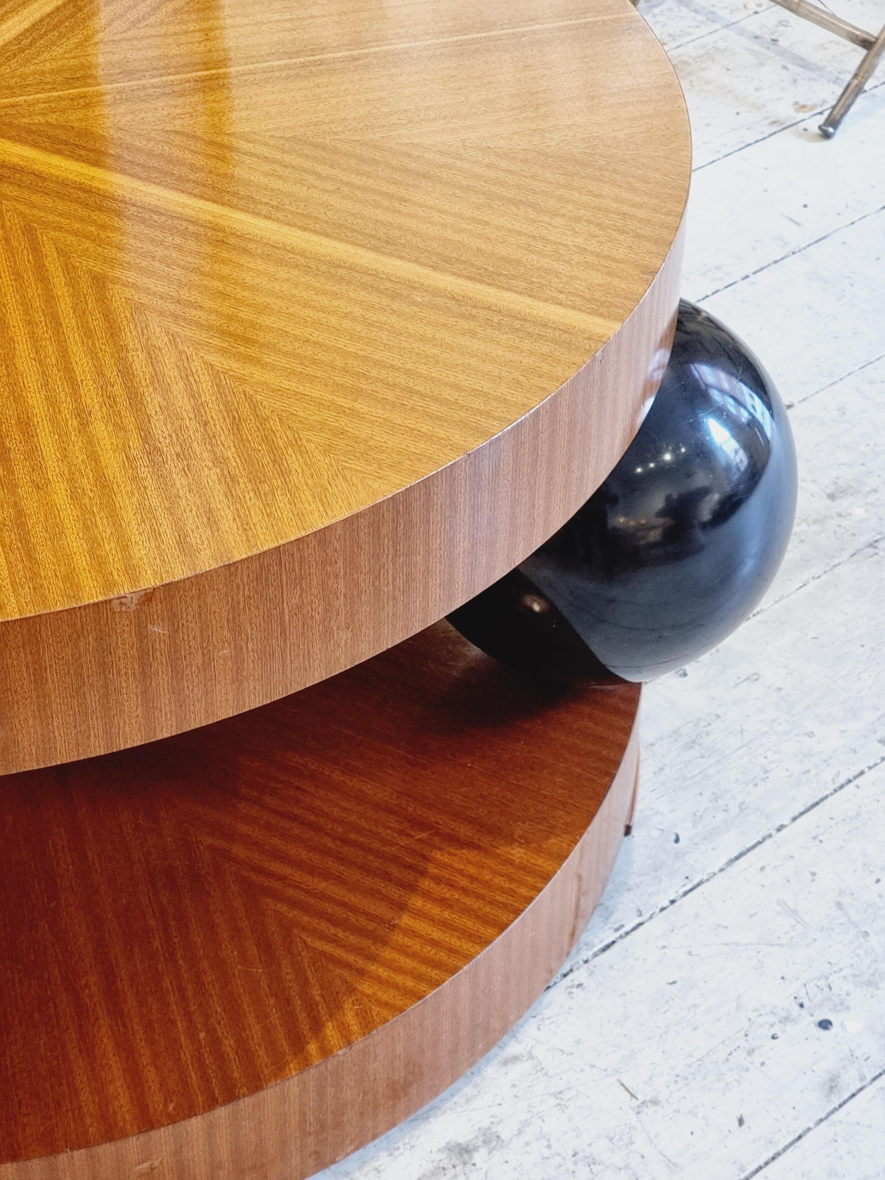 A rare iconic Swedish Art Deco table by Erik Johansson, also know as Klot-Johan. Manufactured by Reiners Möbelfabrik, Mjölby,  early 1940s. 
Table top and base with mahogany veneer and black lacquered round-shaped support. 

Table top diam. 100 cm. 
