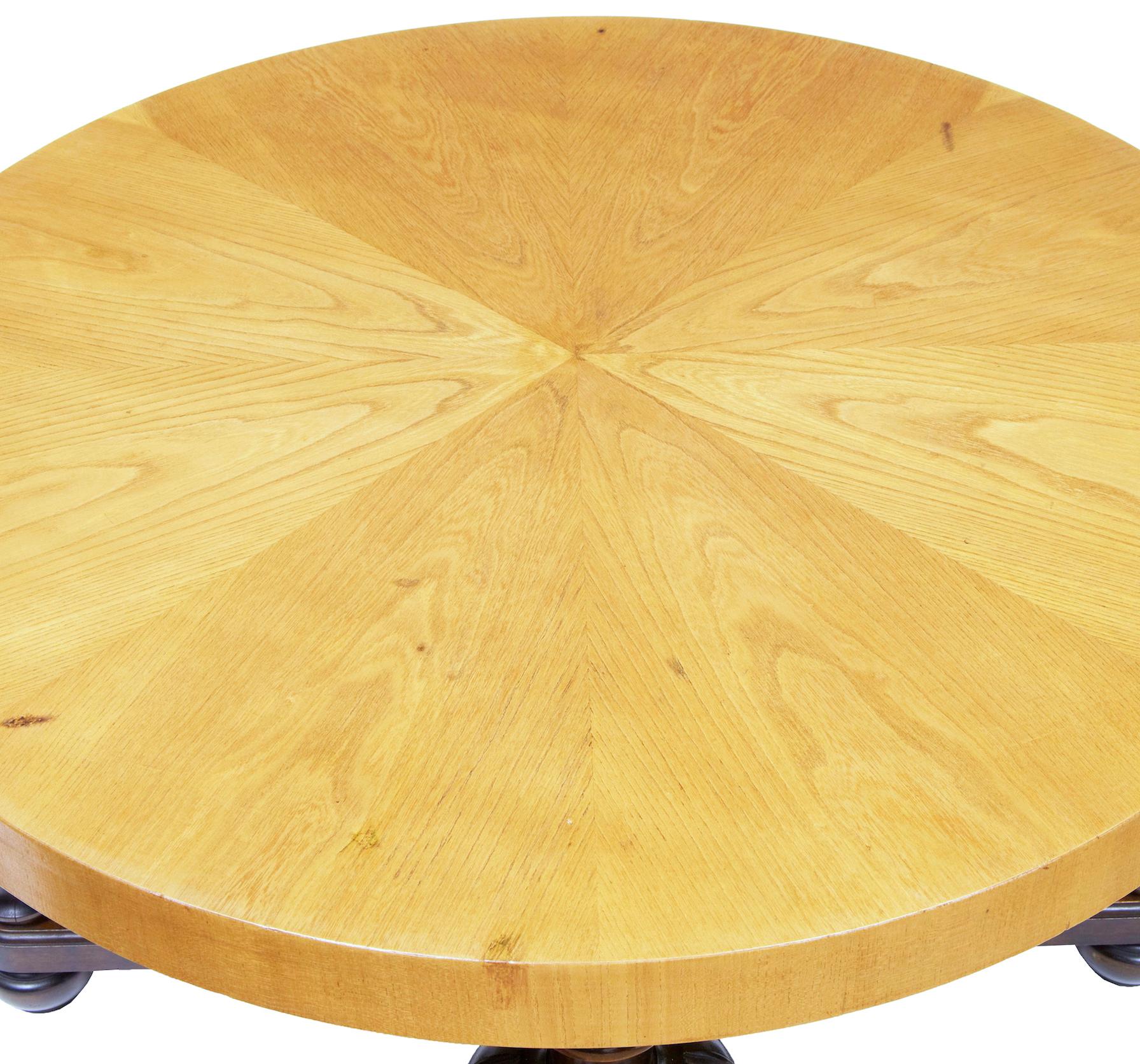 Swedish art deco elm and birch coffee table circa 1930.

Segmented elm circular top surface, standing on 4 bulbous and fluted legs, united by an x frame stretcher.  Standing on turned feet.

Minor restorations to veneer.