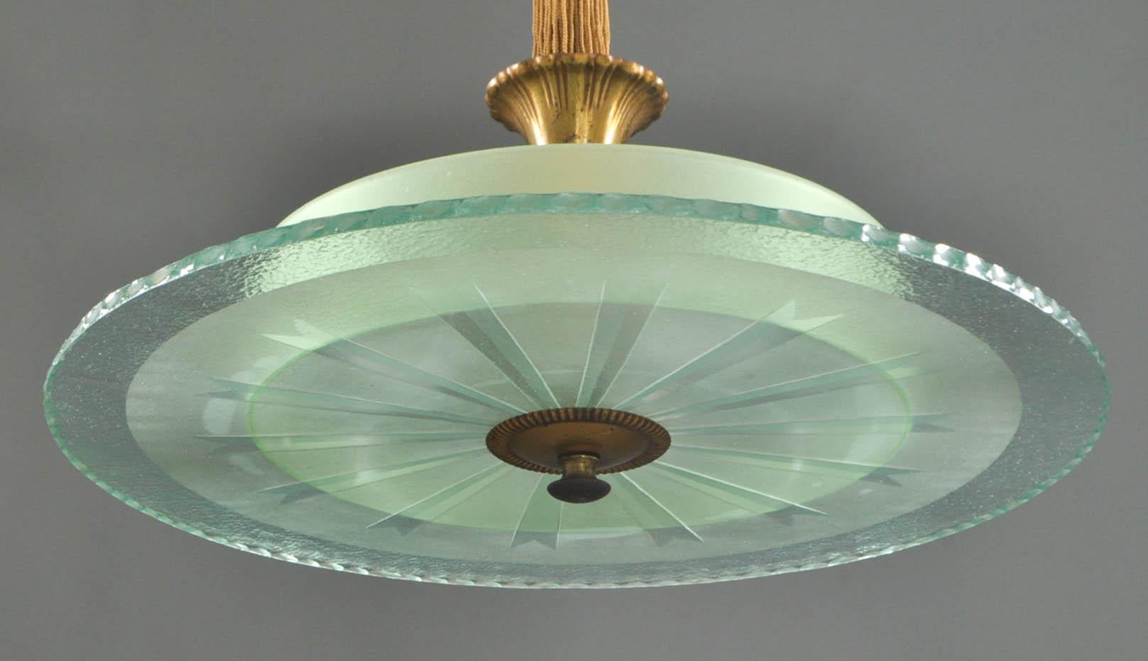 Swedish Art Deco etched glass art deco chandelier/pendant. The light comprised of a gilt metal, tassel and rope canopy and stem ending in two green glass discs, the lower one with notched edge and engraved ray pattern, circa 1920s Attributed to