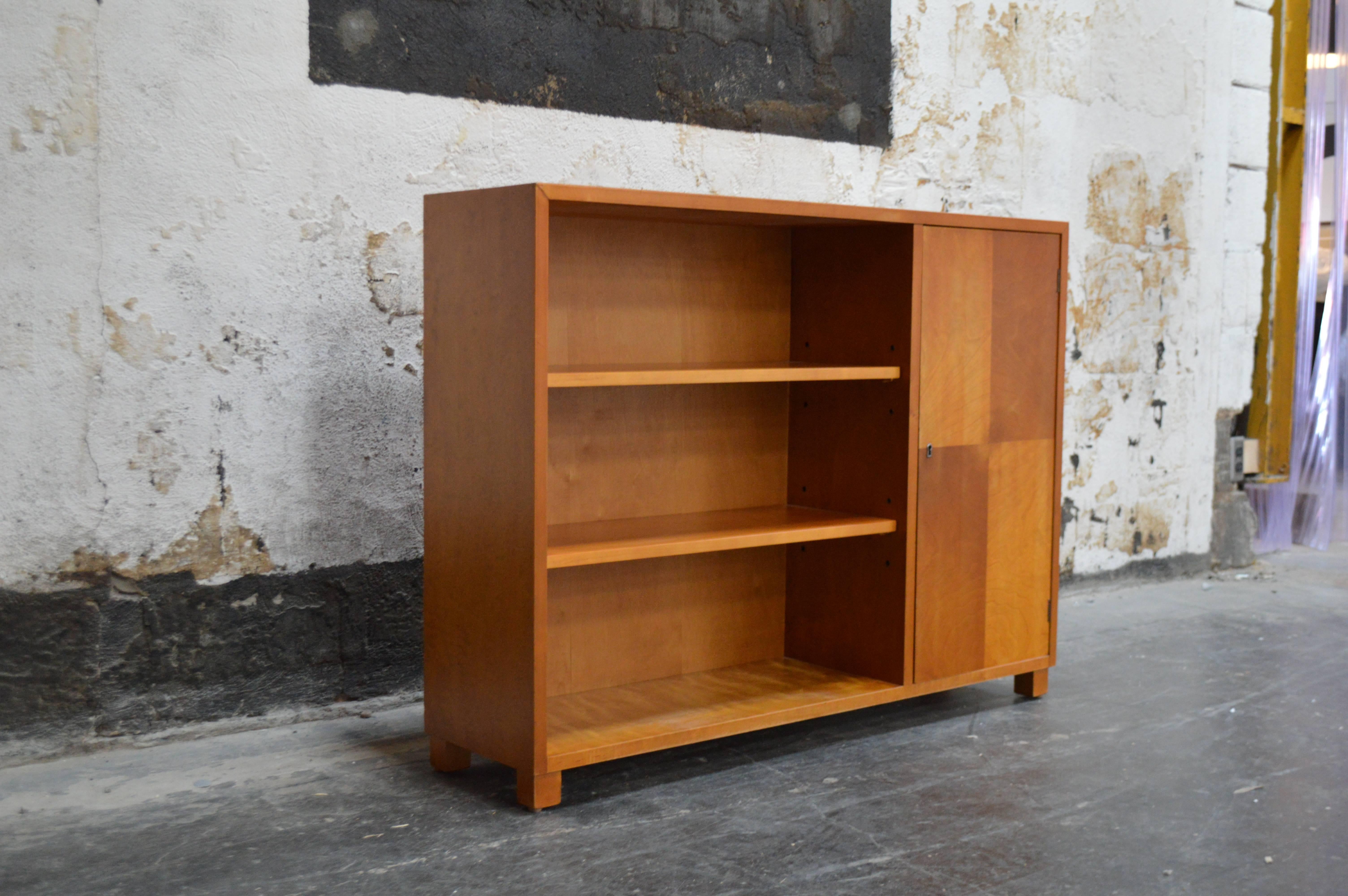 Art Deco/Art Moderne bookcase was cabinet crafted of native golden birch with parquetry door. This gorgeous wood has mellowed to a rich amber color. Adjustable shelves. Key included.