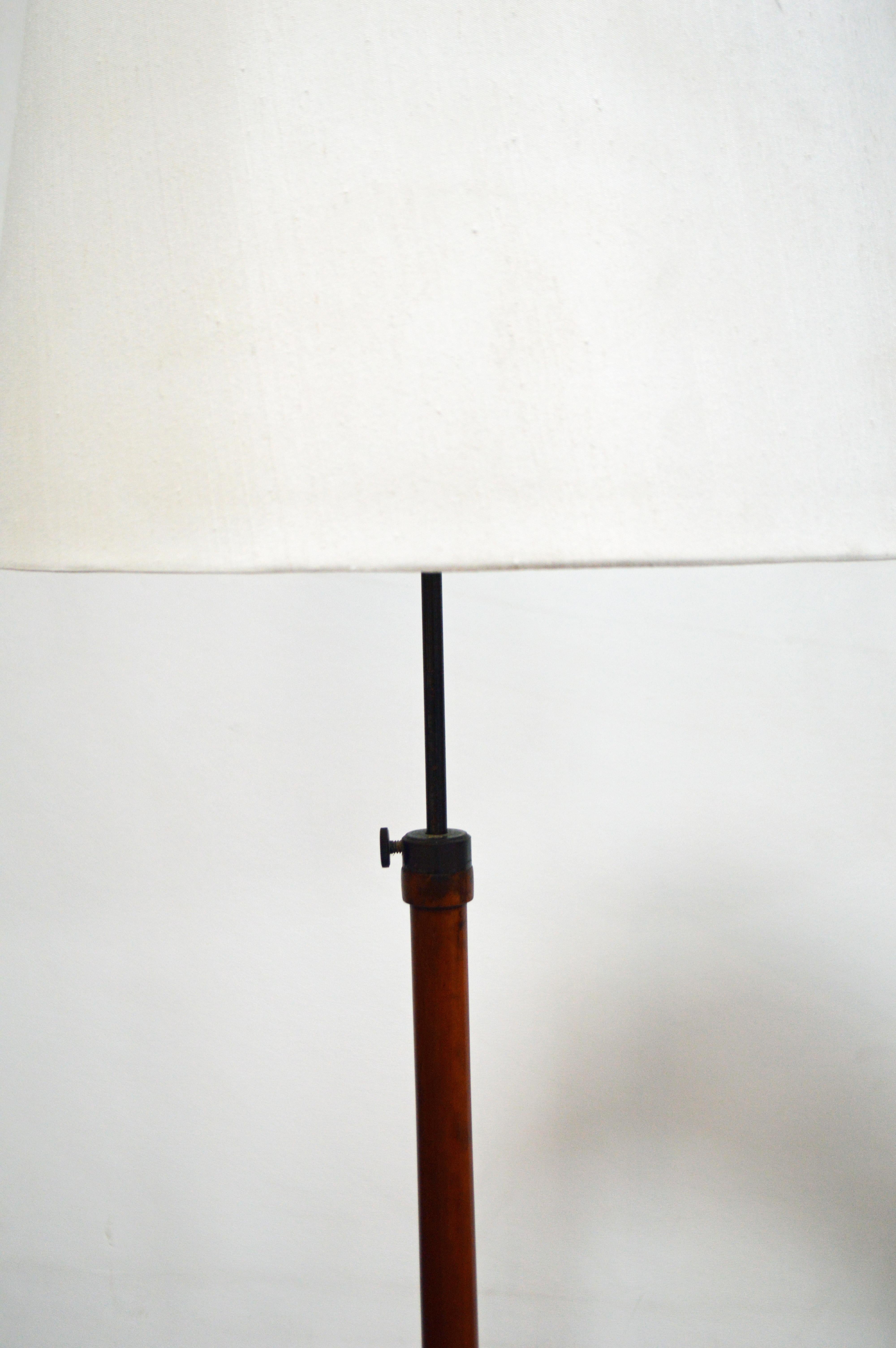 Very handsome and sleek Art Deco floor lamp in excellent restored condition. The overall height is adjustable to higher and lower positions. The base measures 11” in diameter and is comprised of flame birch and chrome with an ebonized ball detail.