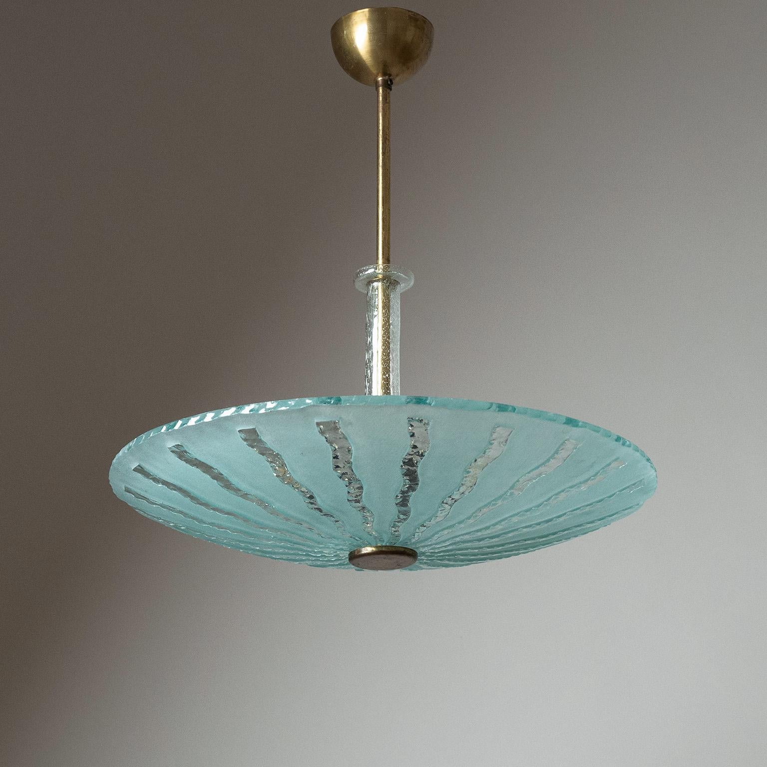 Rare Swedish Art Deco glass ceiling light from the 1930s. Thick ‚raw glass‘ diffuser with a frosted finish and chipped edge and sun ray motif. Three original bakelite E27 sockets with new wiring.
Measures: Height 51cm (20″), Diameter 49cm (19″),