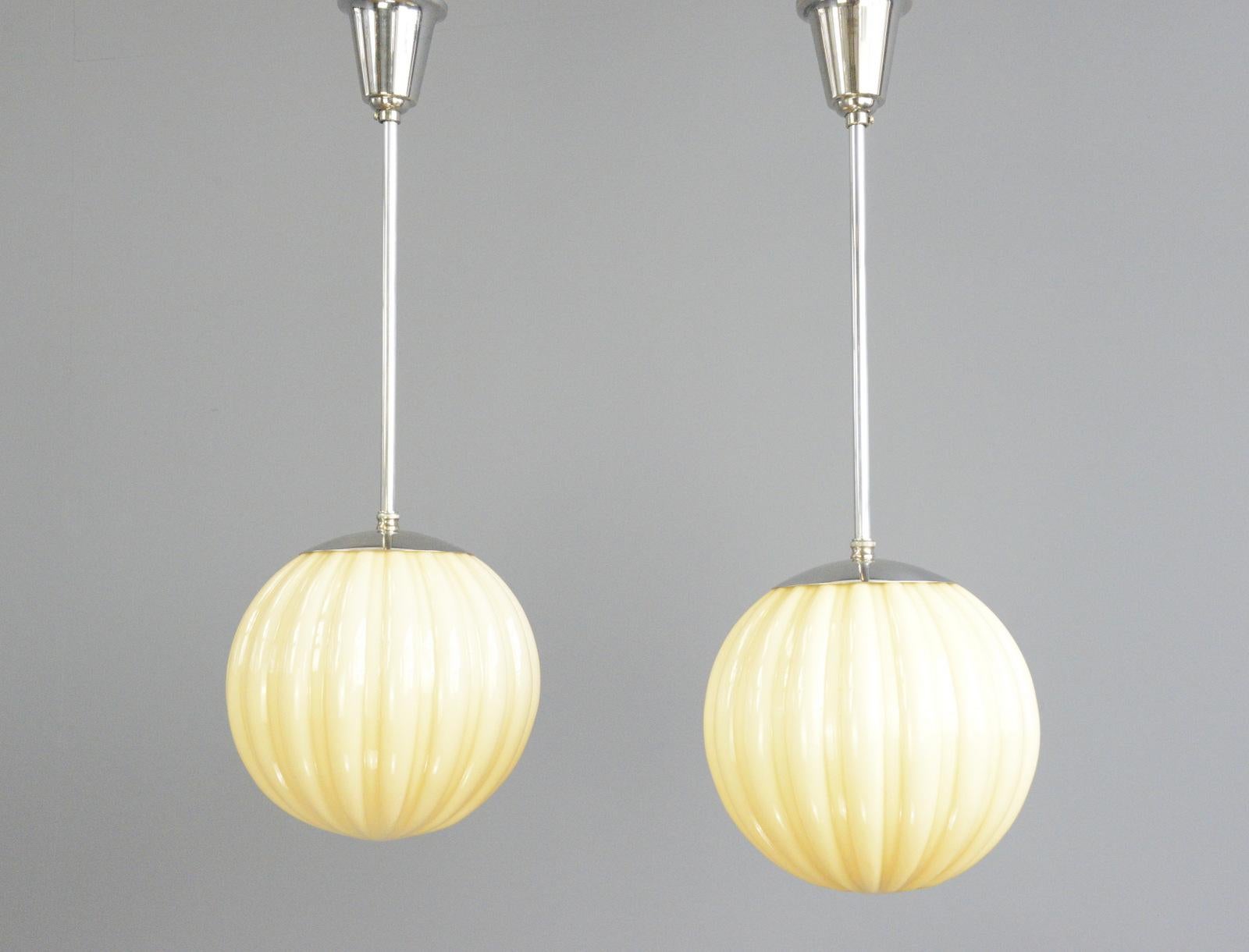 Swedish Art Deco globe pendant lights Circa 1920s.

- Mustard coloured glass
- Textured ribbed glass
- Nickel tops, stems and ceiling rose
- Takes E27 fitting bulbs
- Swedish ~ 1920s
- 26cm x 68cm tall inc stem and ceiling rose

Condition