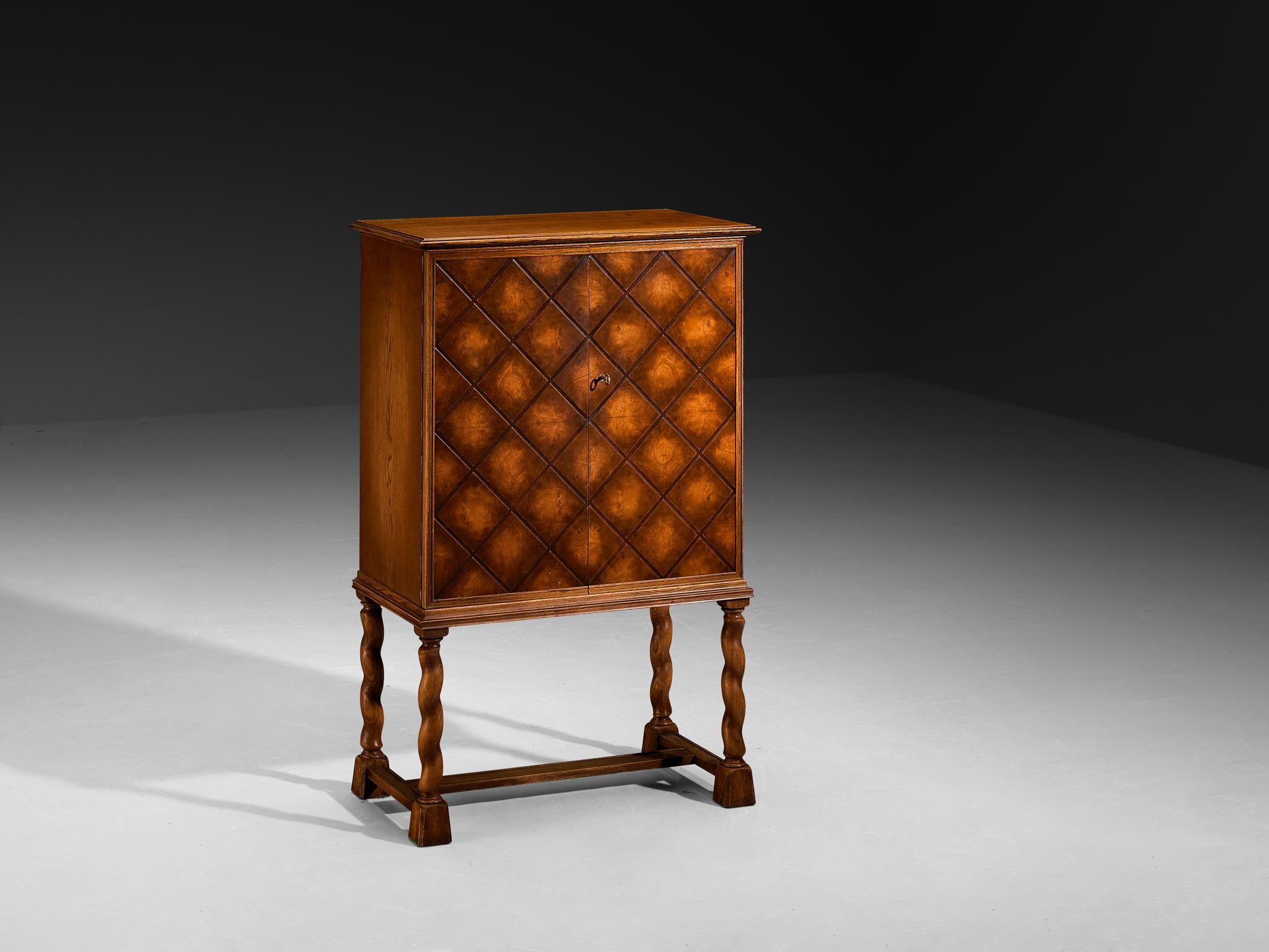 Thysells Möbler, high-legged sideboard, oak, Sweden, 1940s

This elegant sideboard is designed according to the stylistic principles of the so-called Swedish Grace style. The corpus features intricate geometric carvings with squares and diagonal
