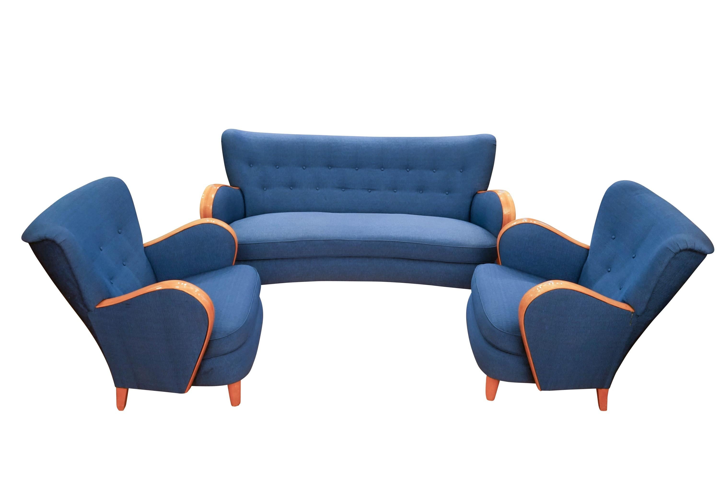 A curved, tailored sofa with swing, is complemented by a pair of matching extremely comfortable chairs. The comfort is due, in part, to the hand tailoring of the sofa and chair backs with strategically placed flat buttons which remove unnecessary