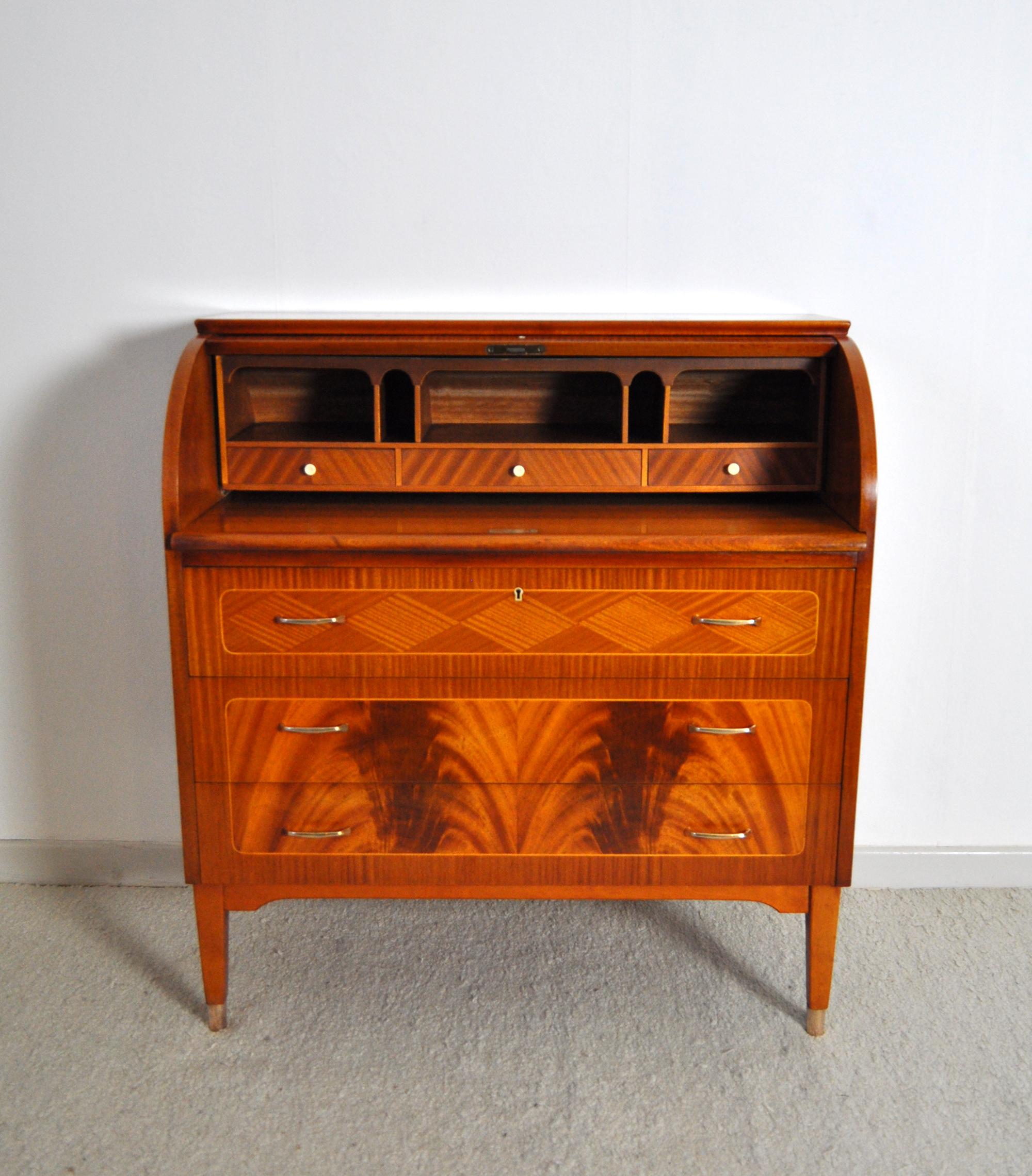 Swedish cabinetmaker roll-top secretary with a pull out / pull-out writing desk. Made in mahogany with beautiful inlaid parquetry details. Top rolls up to reveal cubby holes and 3 small drawers. Lower section has three large drawers with solid brass