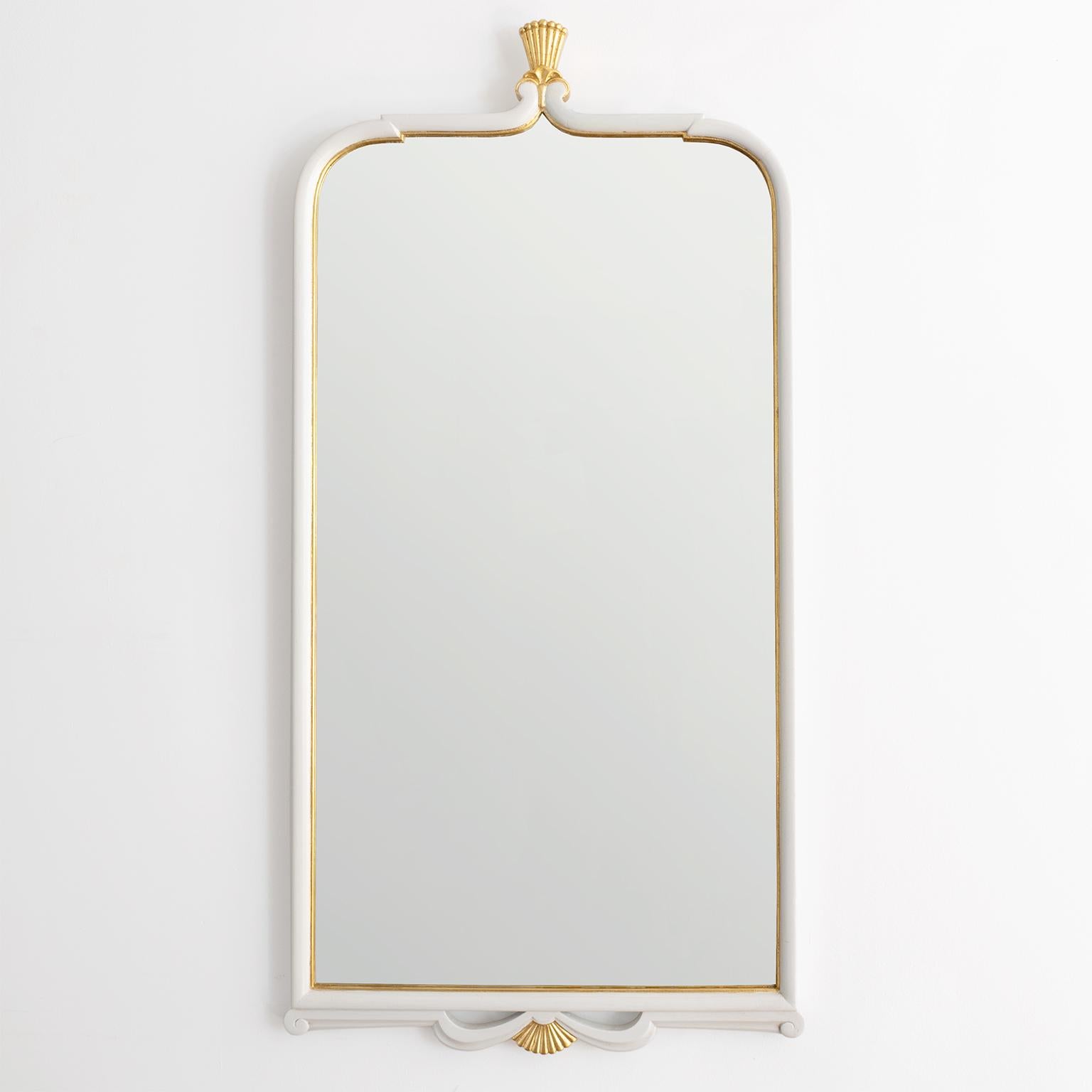 Swedish Art Deco carved wood wall mirror in a light pale gray lacquer with crown and shell forms detailed in gold. Newly restored, mirror has original glass. 

Measures: Height 41“, width 1.5“, depth 20“.