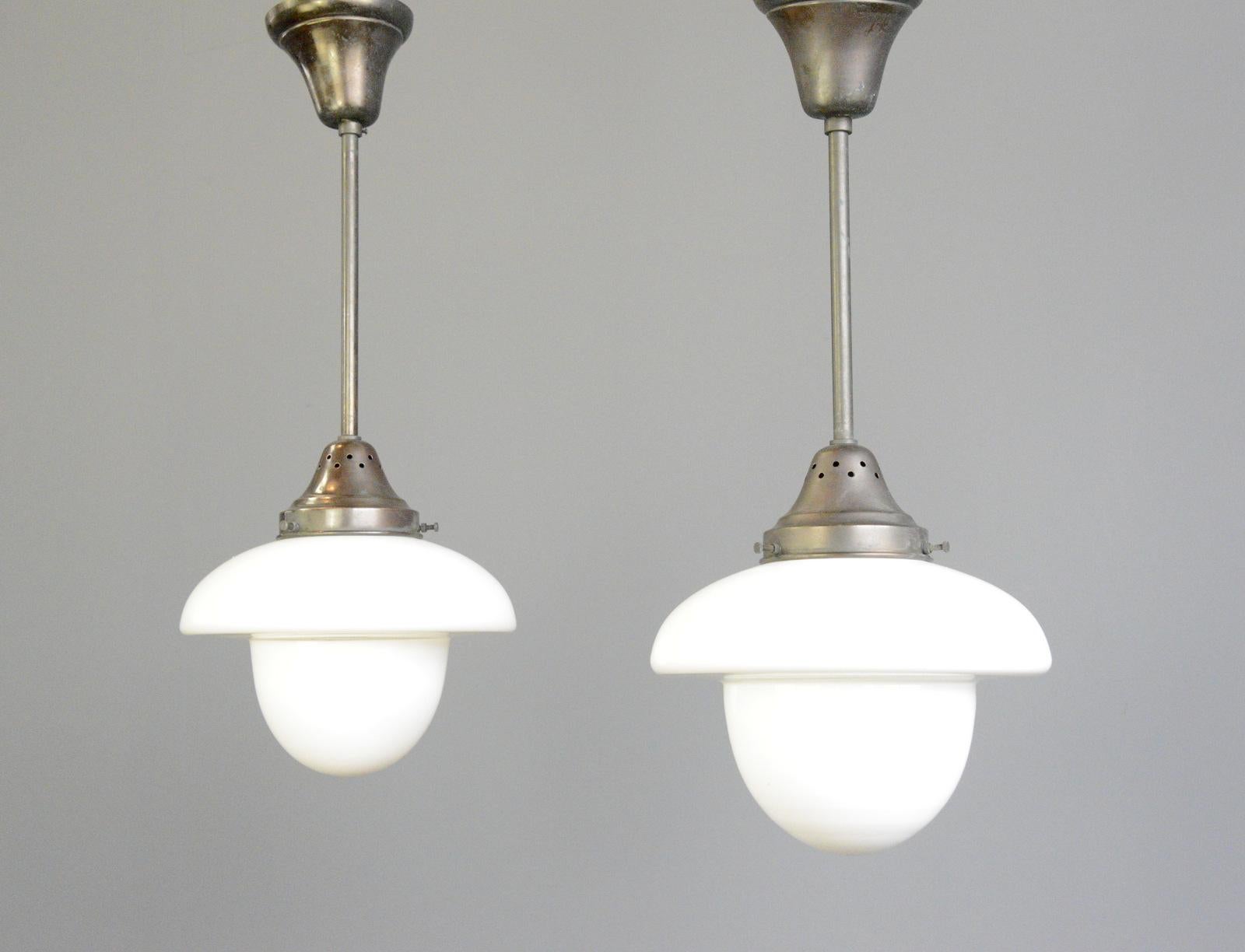 Swedish Art Deco pendant lights by Asea Circa 1920s.

- Acorn shaped Opaline and clear glass 
- Original copper tops, stems and ceiling roses
- Takes E27 fitting bulbs
- Made by Asea
- Swedish ~ 1920s
- 26cm wide x 58cm tall inc ceiling