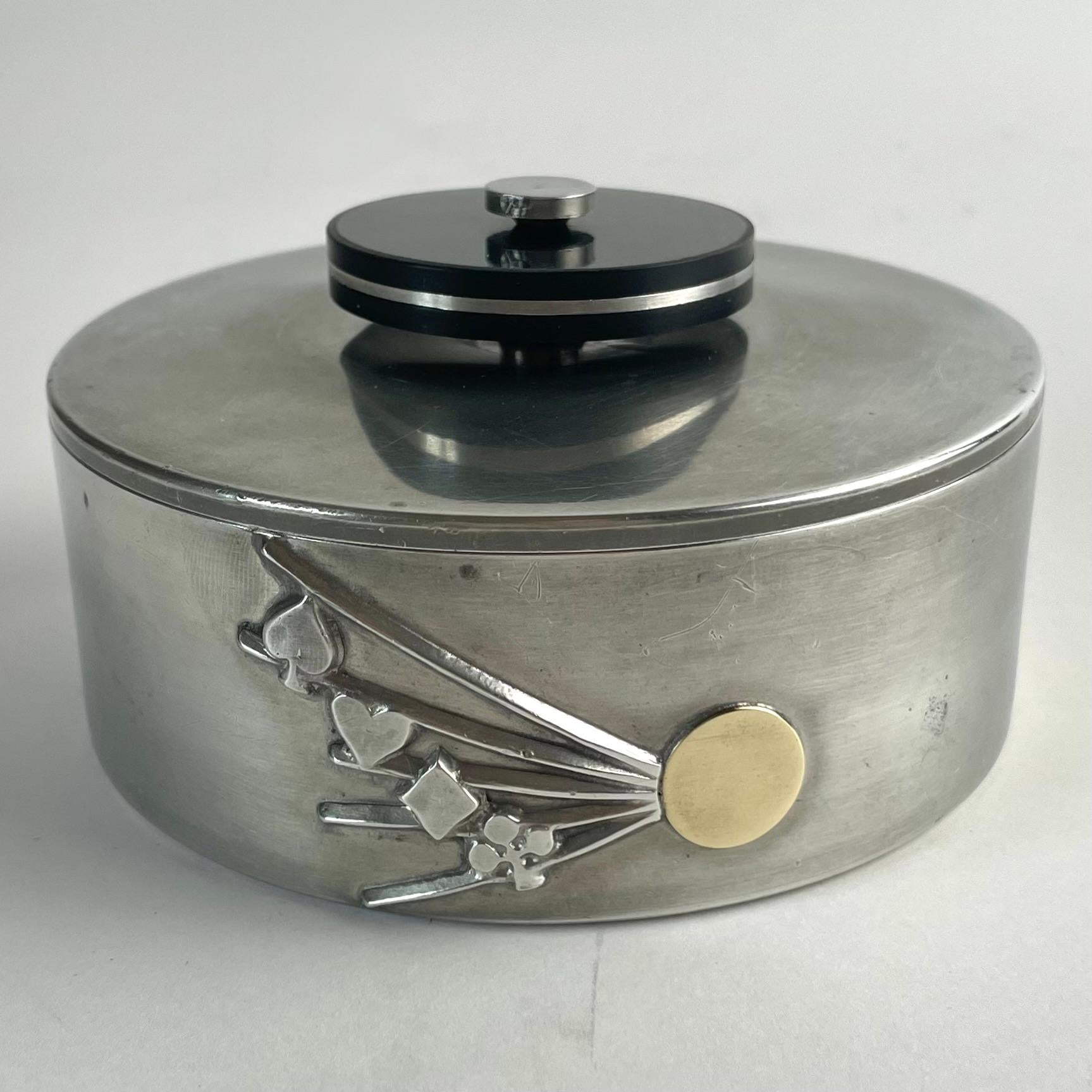 
Swedish Art Deco Pewter, Bakelite, and Brass Lidded Box by GAB, 1935

A refined and elegant lidded box by Guldsmedsaktiebolaget (GAB), Sweden’s premier silversmiths and metalware manufacturer, crafted in 1935 (hallmarked I8). This striking piece
