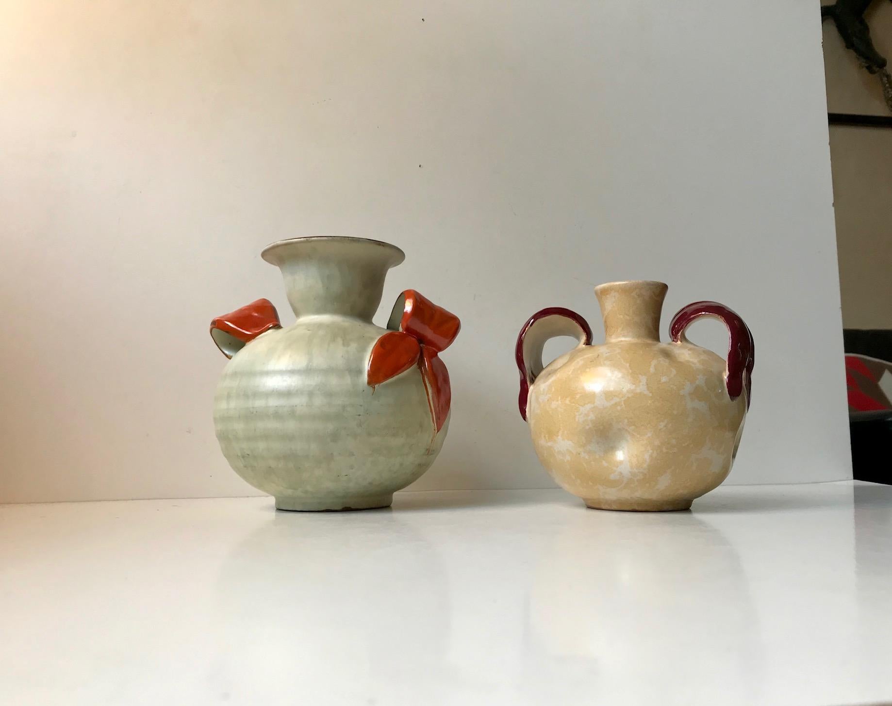 - A set of 1930s ceramic vases decorated with pastel glazes, ribbings, intended 'dents' and colorful bows
- Both vases was designed by Harald Ostergren and manufactured by Ekeby in Uppsala Sweden during the 1930s
- Both vases are marked with model