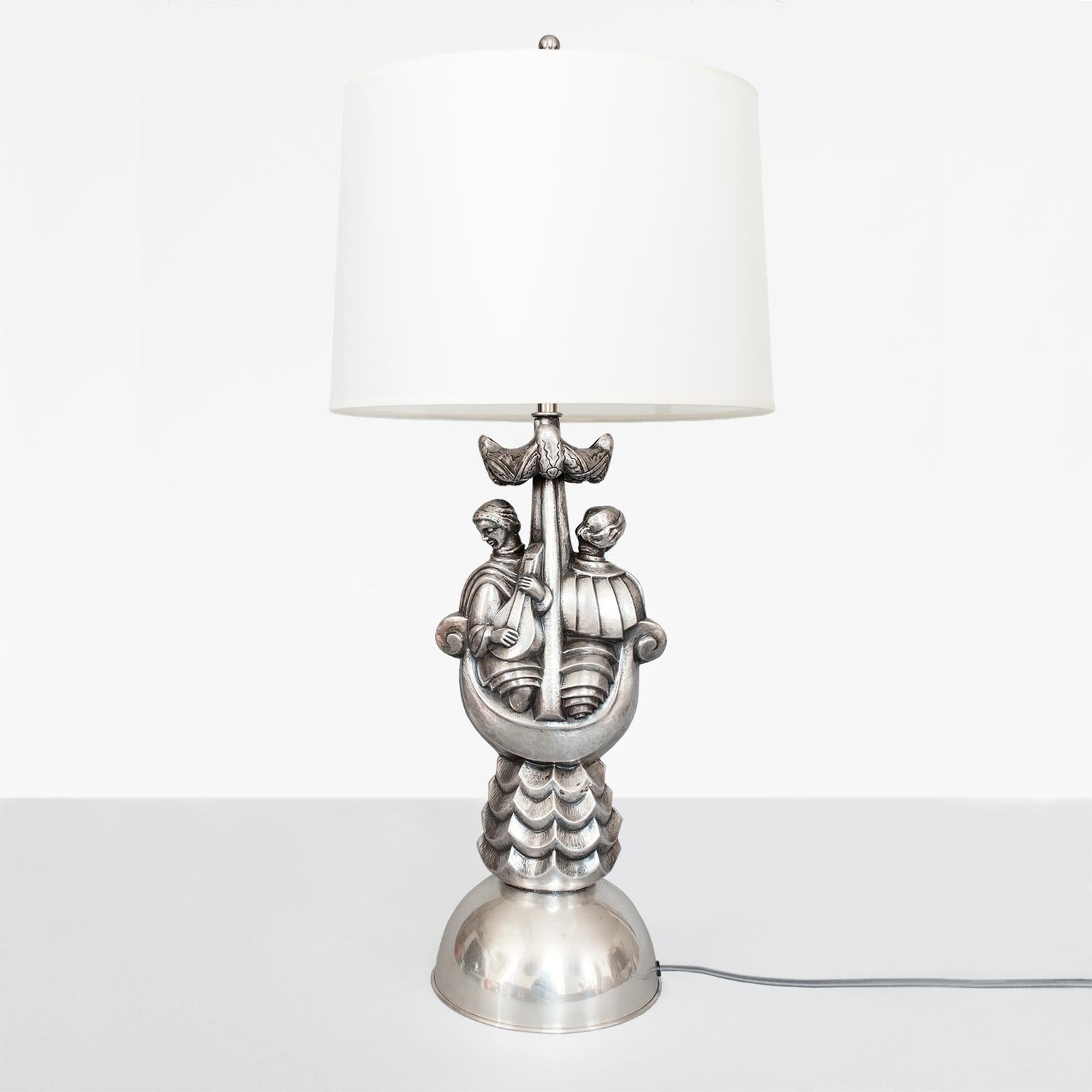 Per Torndahl Swedish Art Deco silver plated metal table lamp designed for Atelier Torndahl, in Perstorp circa 1920s. The lamp depicts a male and female figures in a boat, with stylized waves, mast and sails. Newly electrified with a nickel plated