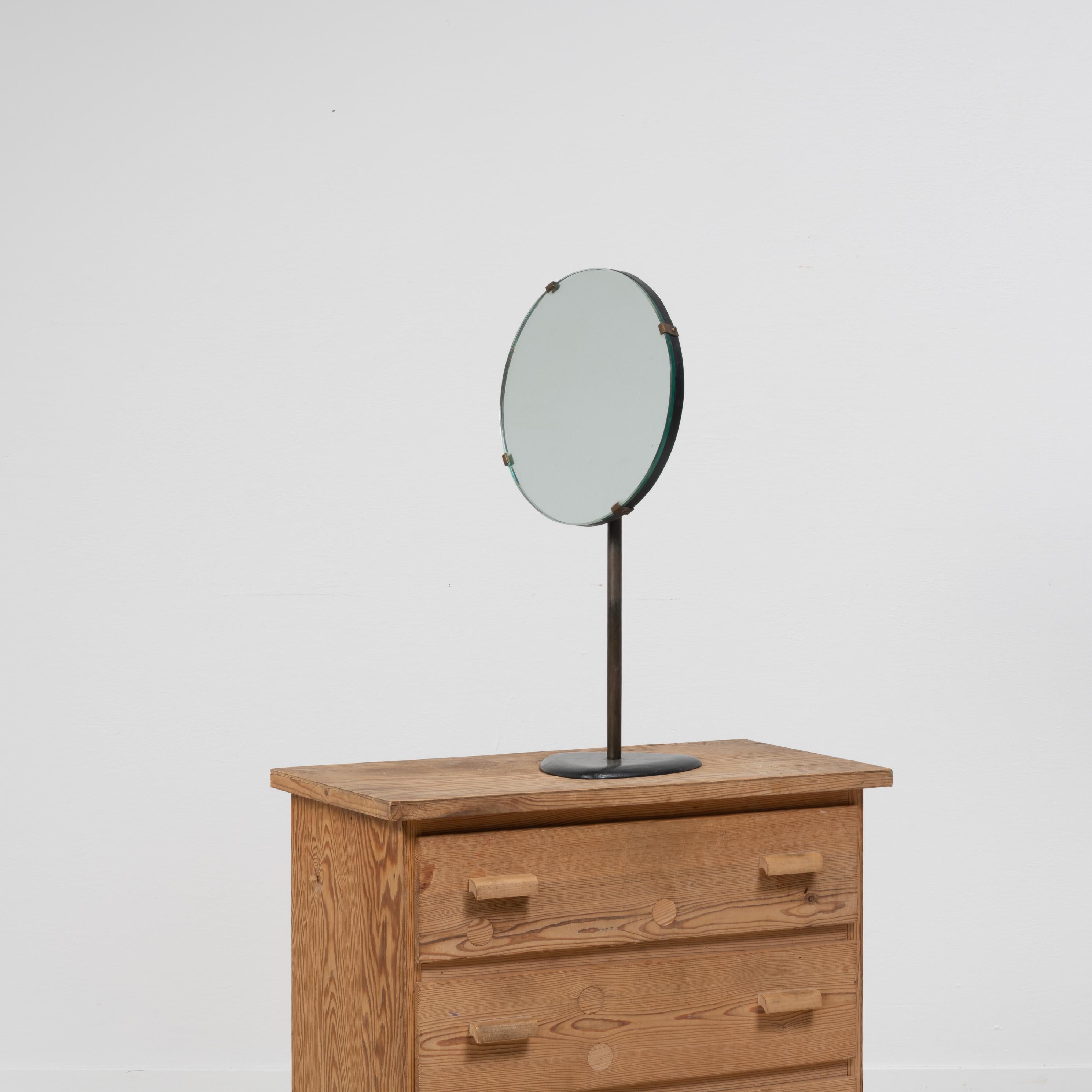 Swedish Art Deco table mirror from the 1930s. The mirror is clean and simple with a timeless and classic design that fits every style. The mirror is on the smaller side and a good size to fit on for example a hallway or vanity table. The foot and