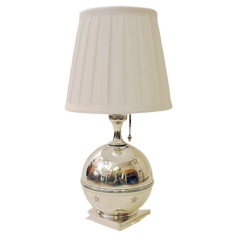 Decorative silverplated table lamp with a round ball design on a silver plated base by GAB (Guldsmedsaktiebolaget)- Sweden 1929. Lovely stars on the surface and a matching hanging metal light switch placed on the bulb holder. Very interesting and