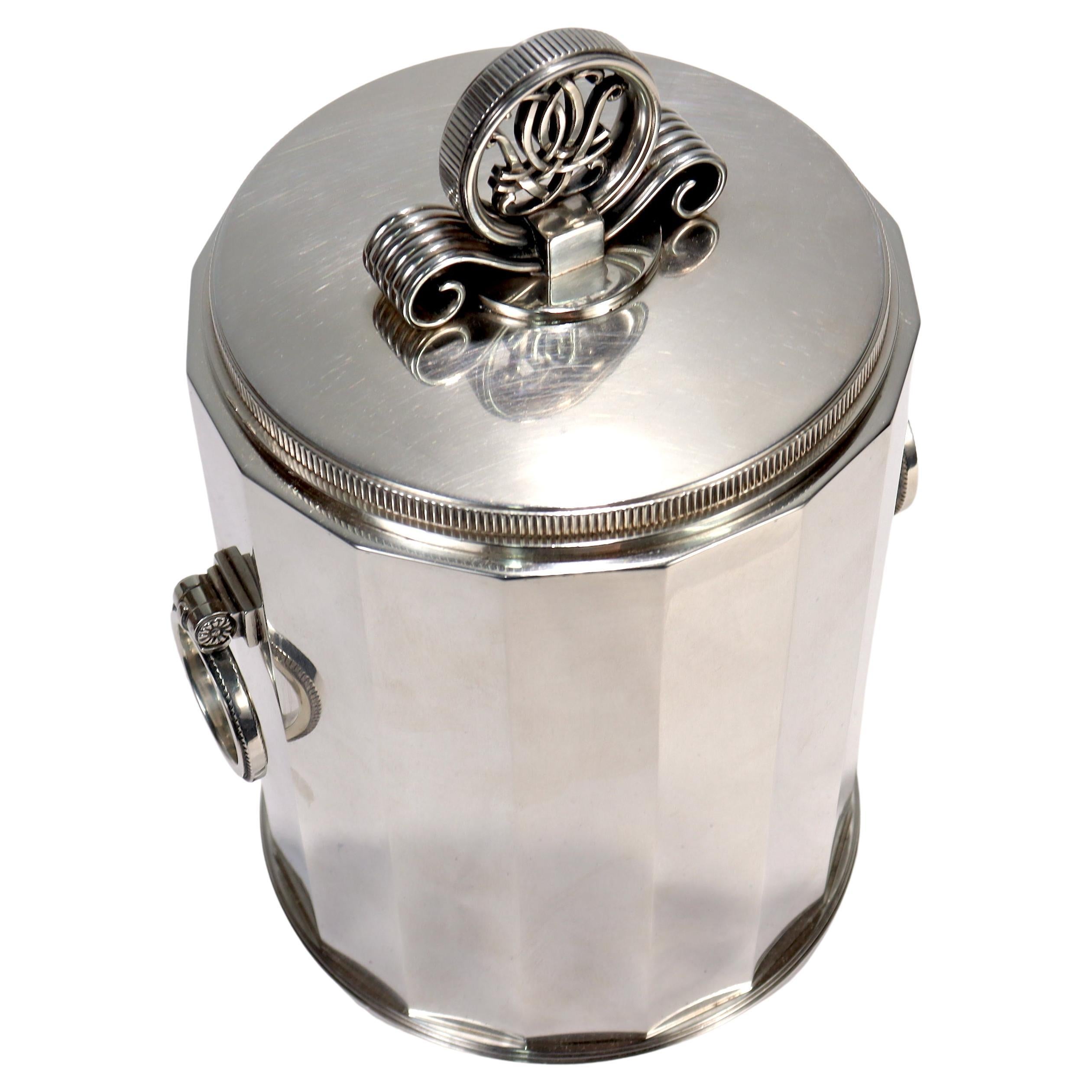 A fine antique humidor or canister. 

In sterling silver. 

Designed by Erik Fleming for Borgila in the 1940's.

With a stepped foot, faceted body, loop twin handles to the sides, and a tightly sealed confrming lid with an Art Deco finial. 

The