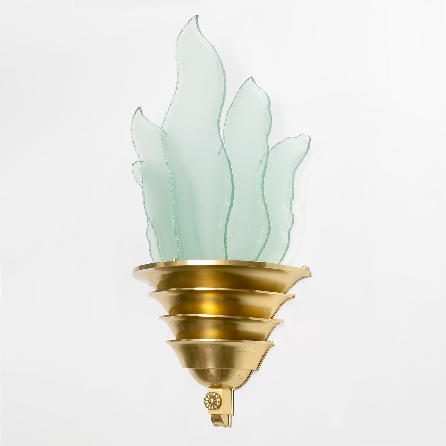 A large dramatic Scandinavian Modern, Swedish Art Deco sconce with a tiered brass body which holds 5 handcut, polished and acid etched flame shaped glass panels. Newly polished and lacquered body, wired for use in the USA with 2 standard base