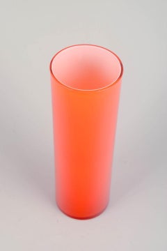 Swedish art glass. Vase in vivid orange glass with tall cylindrical shape, 1970s