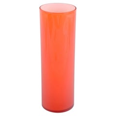 Swedish art glass. Vase in vivid orange glass with tall cylindrical shape, 1970s