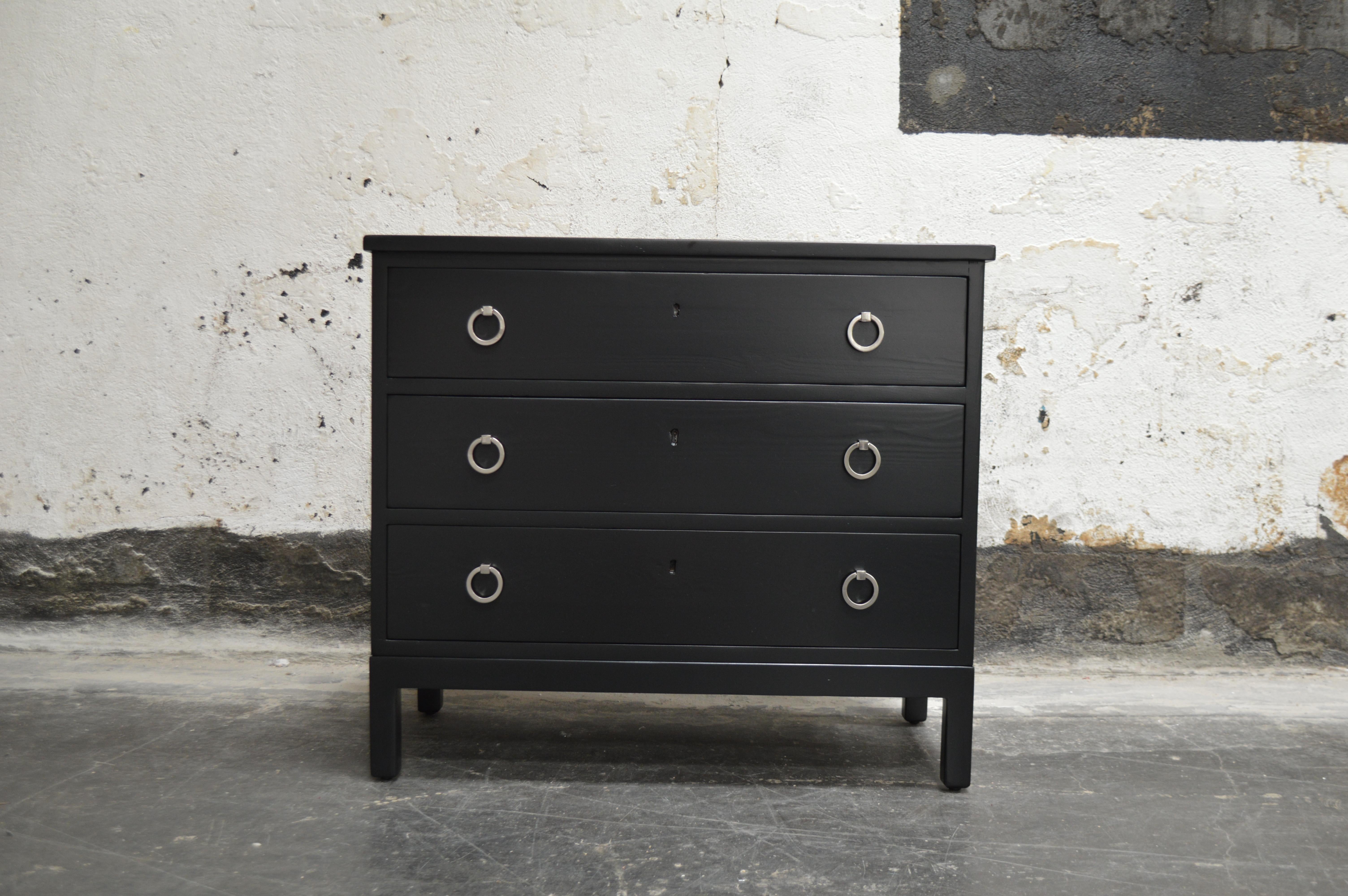 Three-drawer elm chest newly refinished in black lacquer on sleek square legs updated with brushed nickel ring hardware.

A great piece to store your bedding or clothes. A handsome piece of furniture in any room.