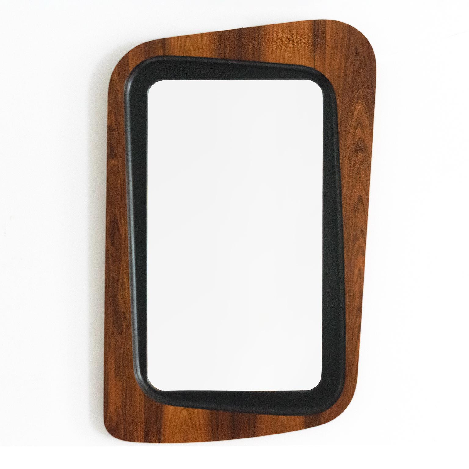 A  Glas & Trä, Hovmantorp made asymmetrical frame wall mirror with rosewood veneer. The inner frame detailed with black lacquer. Made in Sweden circa 1950’s and produced by Glas & Trä, Hovmantorp. 

Height: 33 Width: 22” Depth: 1.25”
