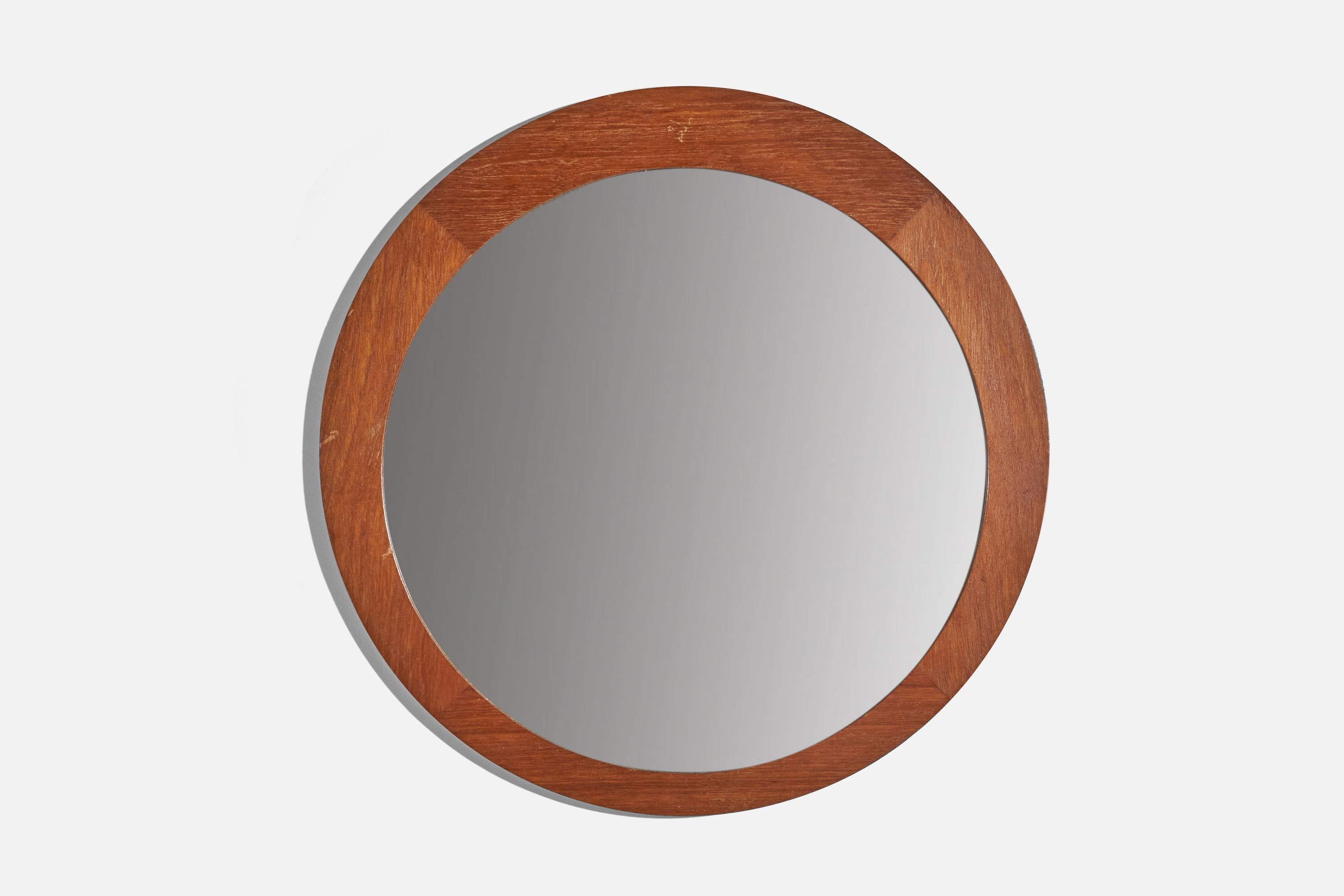 A solid teak wall mirror designed and produced in Sweden, 1960s. 