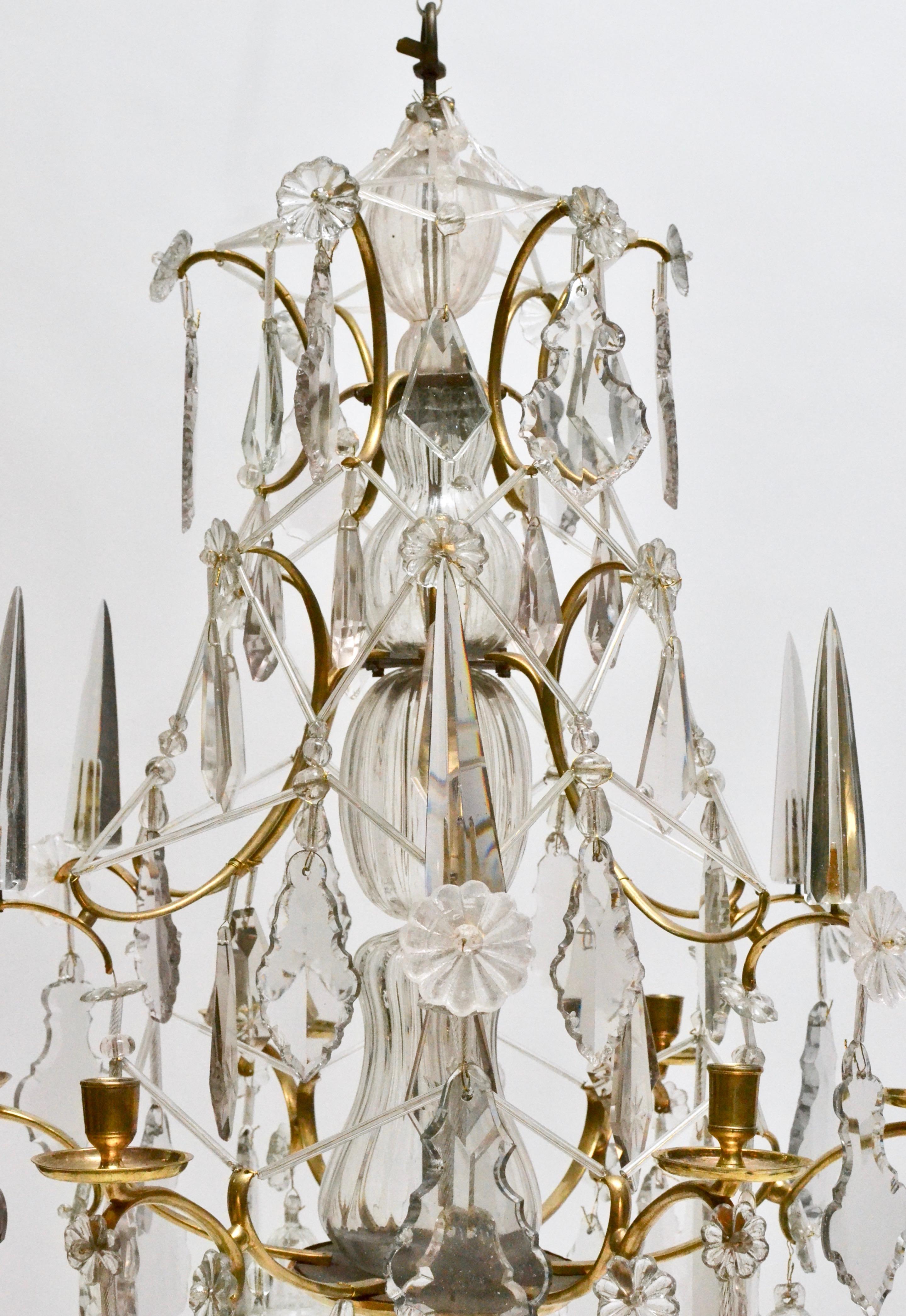 A Swedish Baroque chandelier. Made in Stockholm, 18th century. Pear-shaped brass cage with pear-shaped cut crystals and glass obelisks mounted on the outer middle section. Very nice condition.