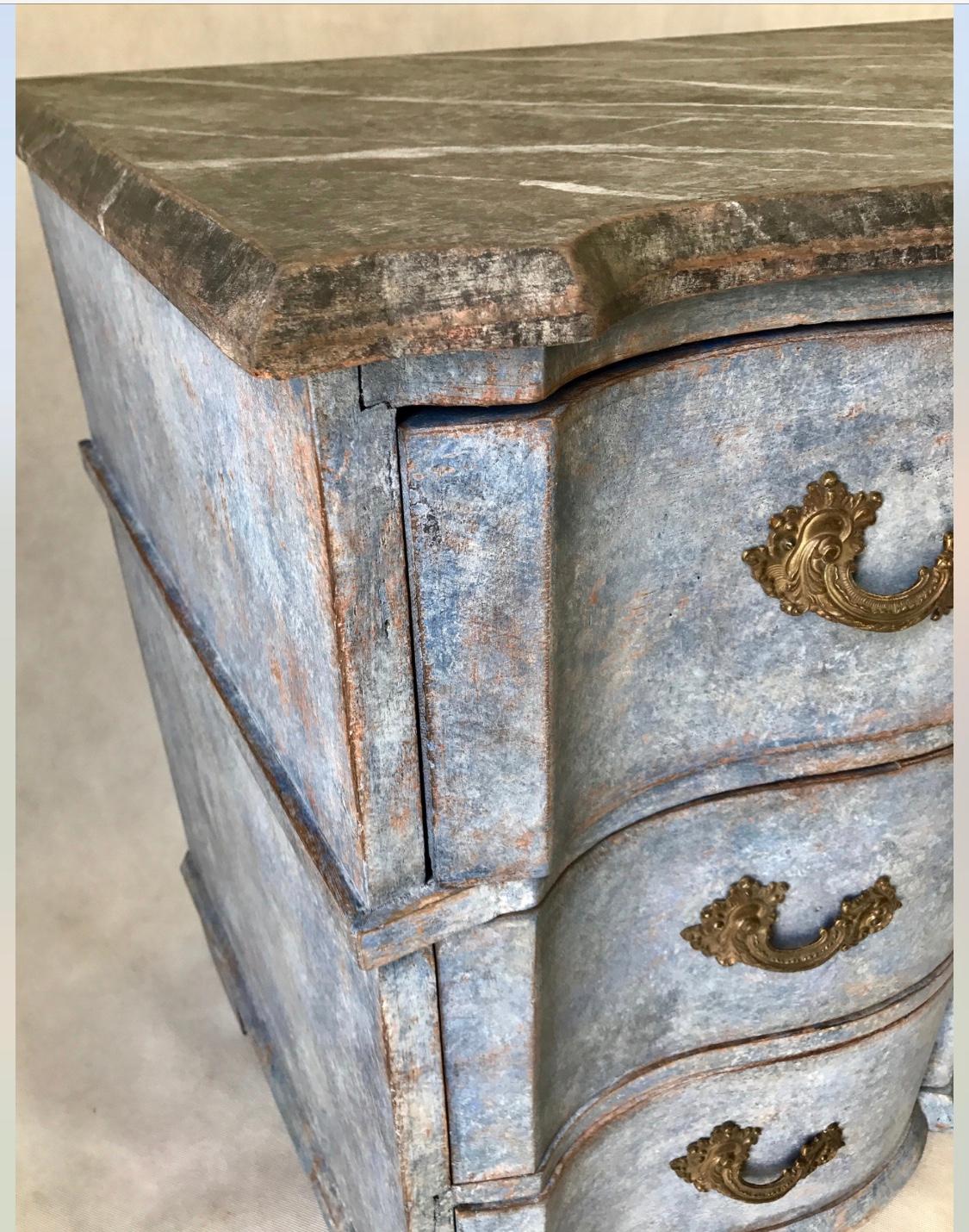 This three-drawer Swedish Baroque chest is a gorgeous saturated blue color with a black faux marble top in great condition, circa 1790-1800. The locks and hardware are original and drawers are generous. A stunning piece that would work in a variety
