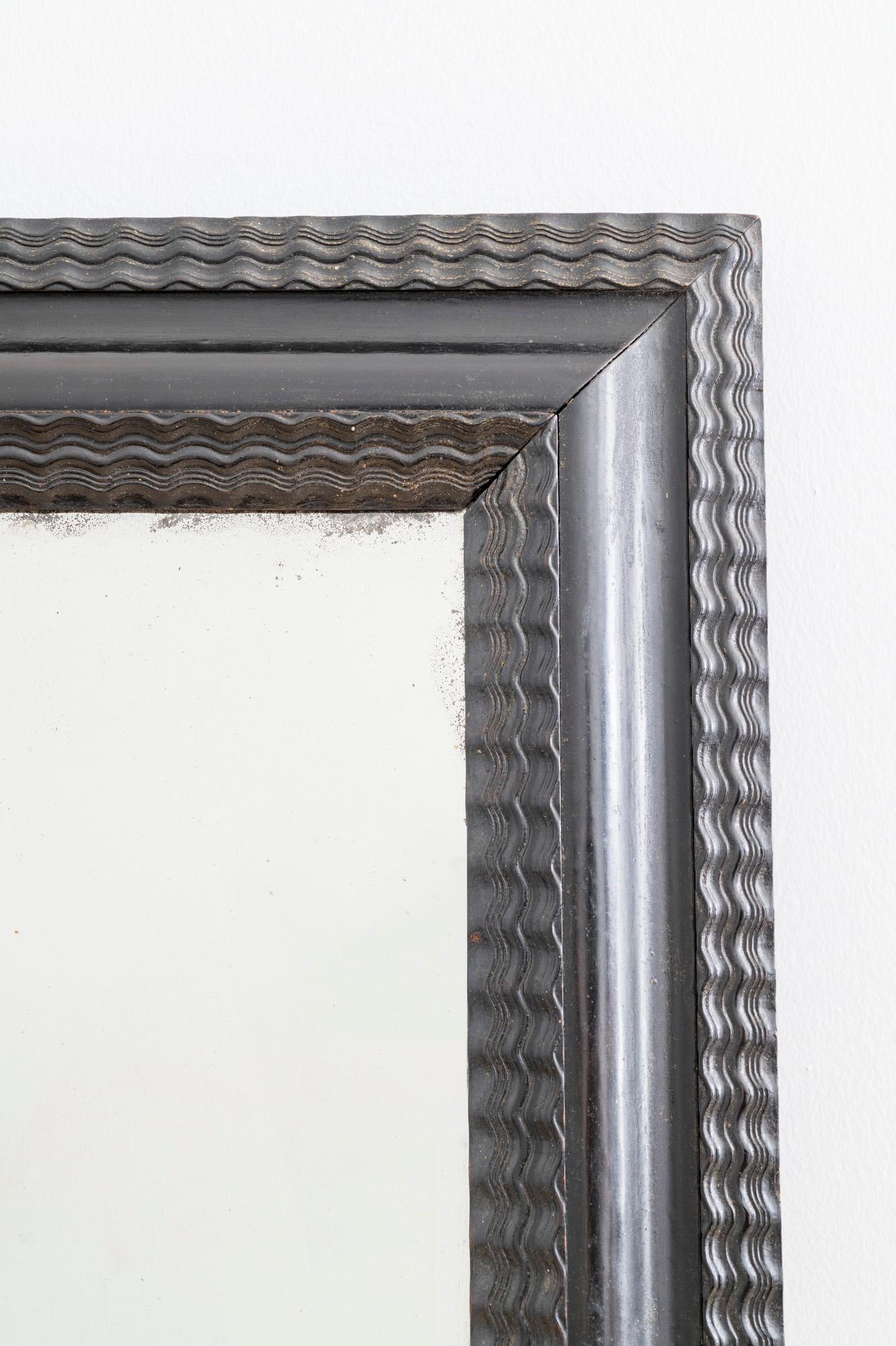 A Swedish Baroque picture frame with mercury foil glass later added to create a mirror.
    