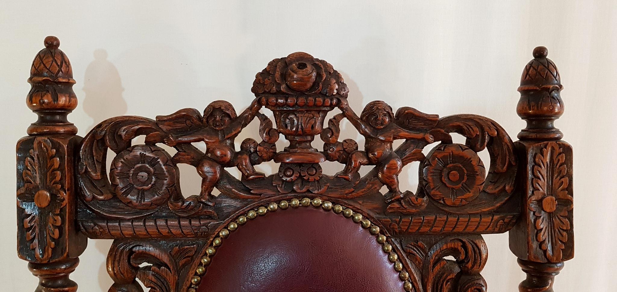 This richly carved Swedish Baroque style armchair with twist legs in oak is from the early 1900s. It has been upholstered with a burgundy leather cushion and back and is in very good condition and ready to use.