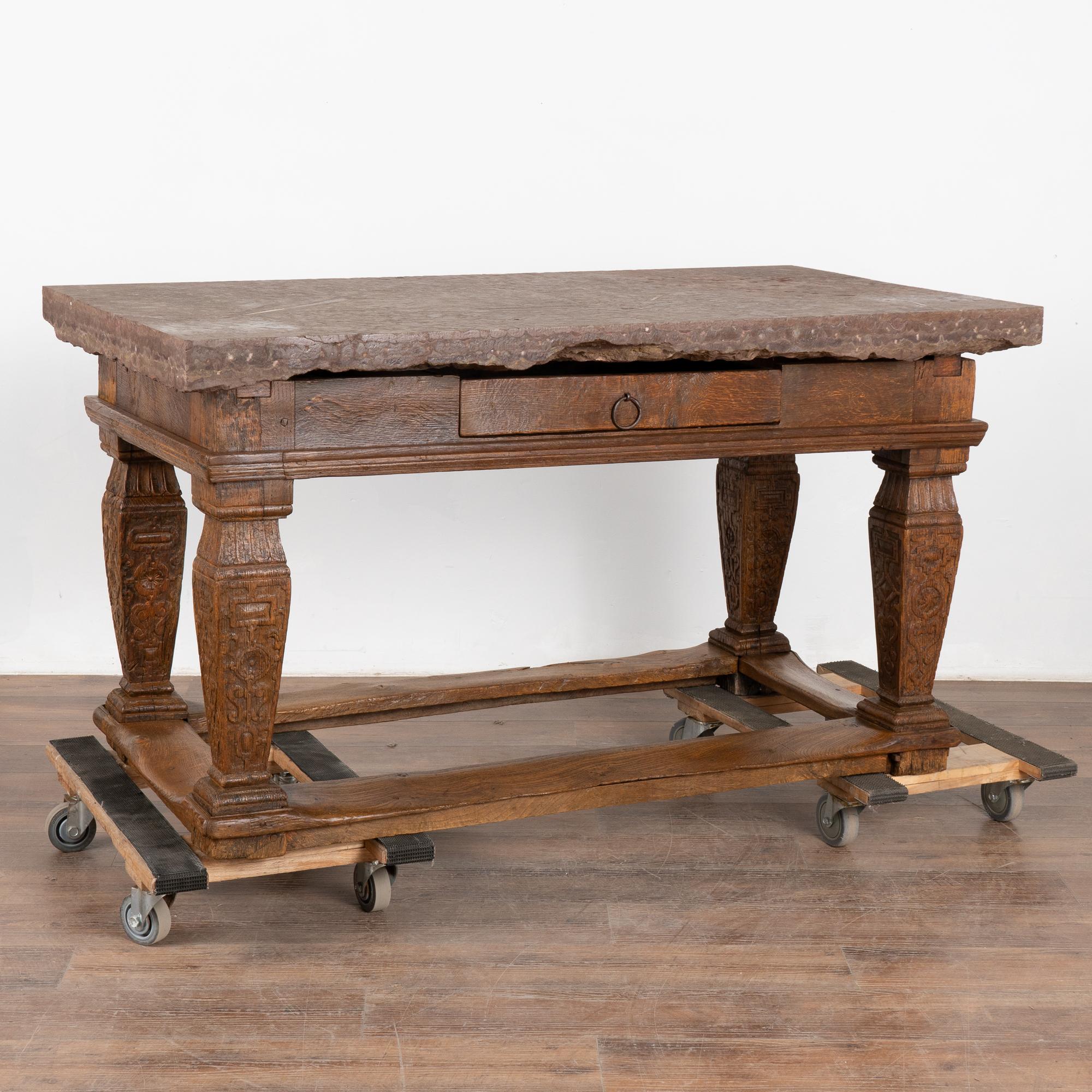 Baroque period stone top table from 18th century, Sweden. This antique kitchen table features the original stone top and single drawer, all resting on heavy turned oak legs and trestle. This table will make an impressive kitchen island or entry