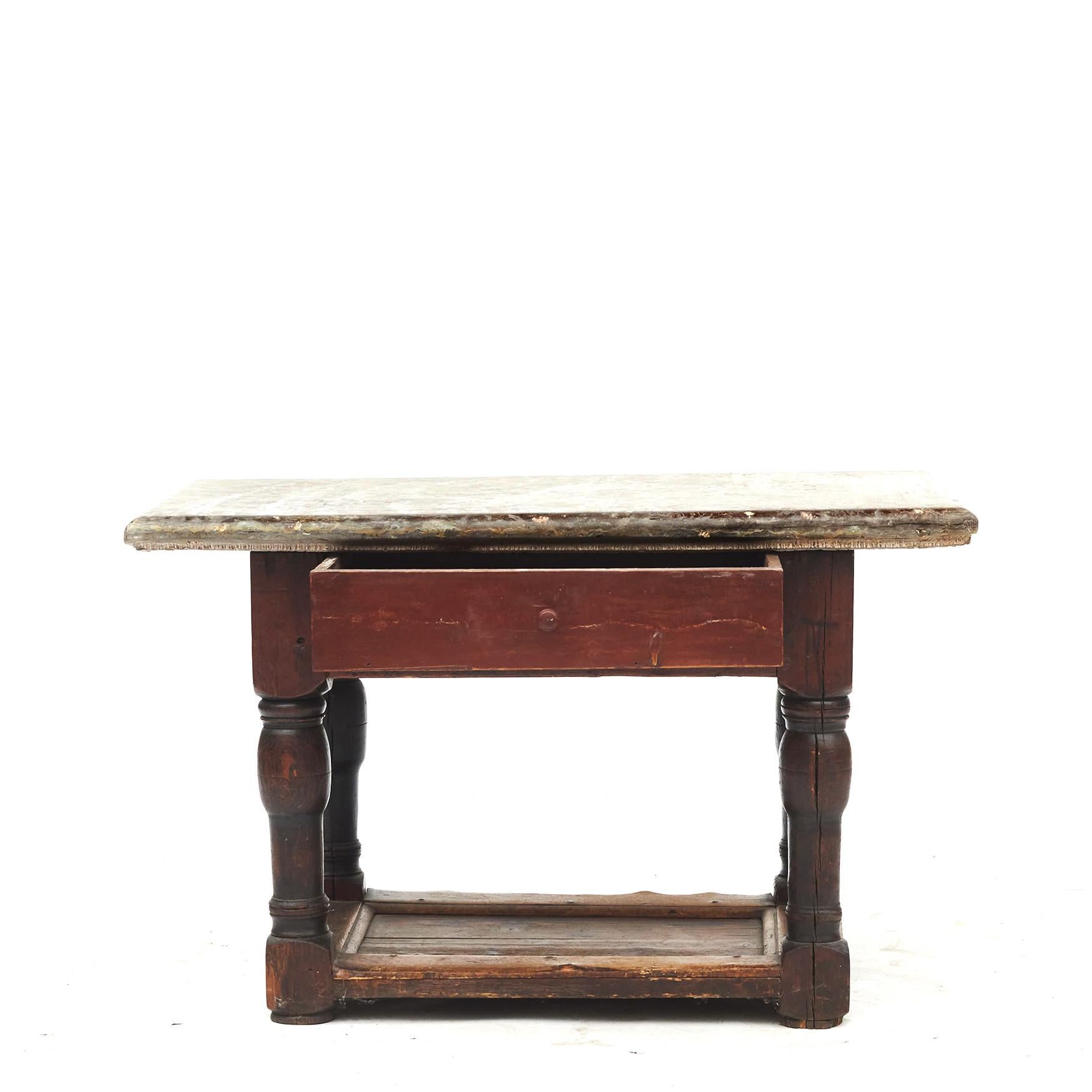 Swedish Baroque table. Original red painted pine with age-related patina.
Öland fossil limestone top resting on a drawer and typical Baluster-shaped Baroque legs.
Sweden circa 1750-1770.
Charming table.
