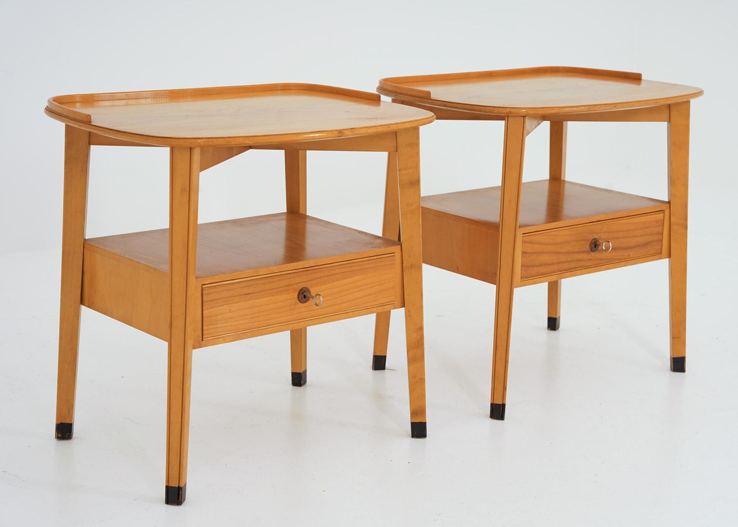 A pair of rare bedside tables manufactured by Nordiska Kompaniet (NK), Sweden, ca 1950.
The design is minimalistic with beautiful details, such as the dark wood, surrounding the key hole.

Condition: Good original condition with some light scratches