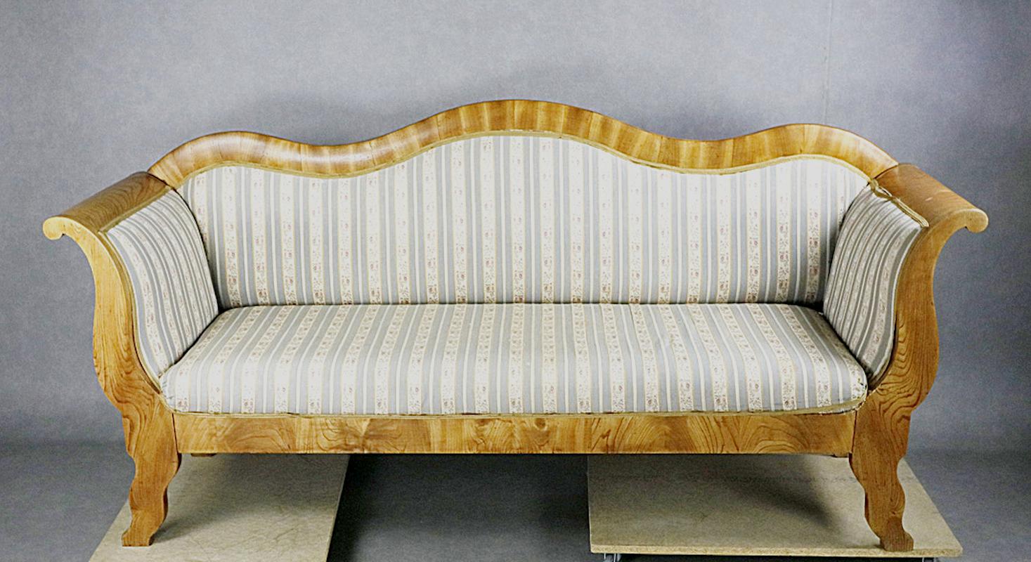 Antique Swedish Biedermeier Empire sofa in top grade quilted figured veneers in the sort after light honey rich deep French polish finish. 

Lovely swooping legs, arms and back with a bench webbed seat and webbed back. It’s a very unusual shape