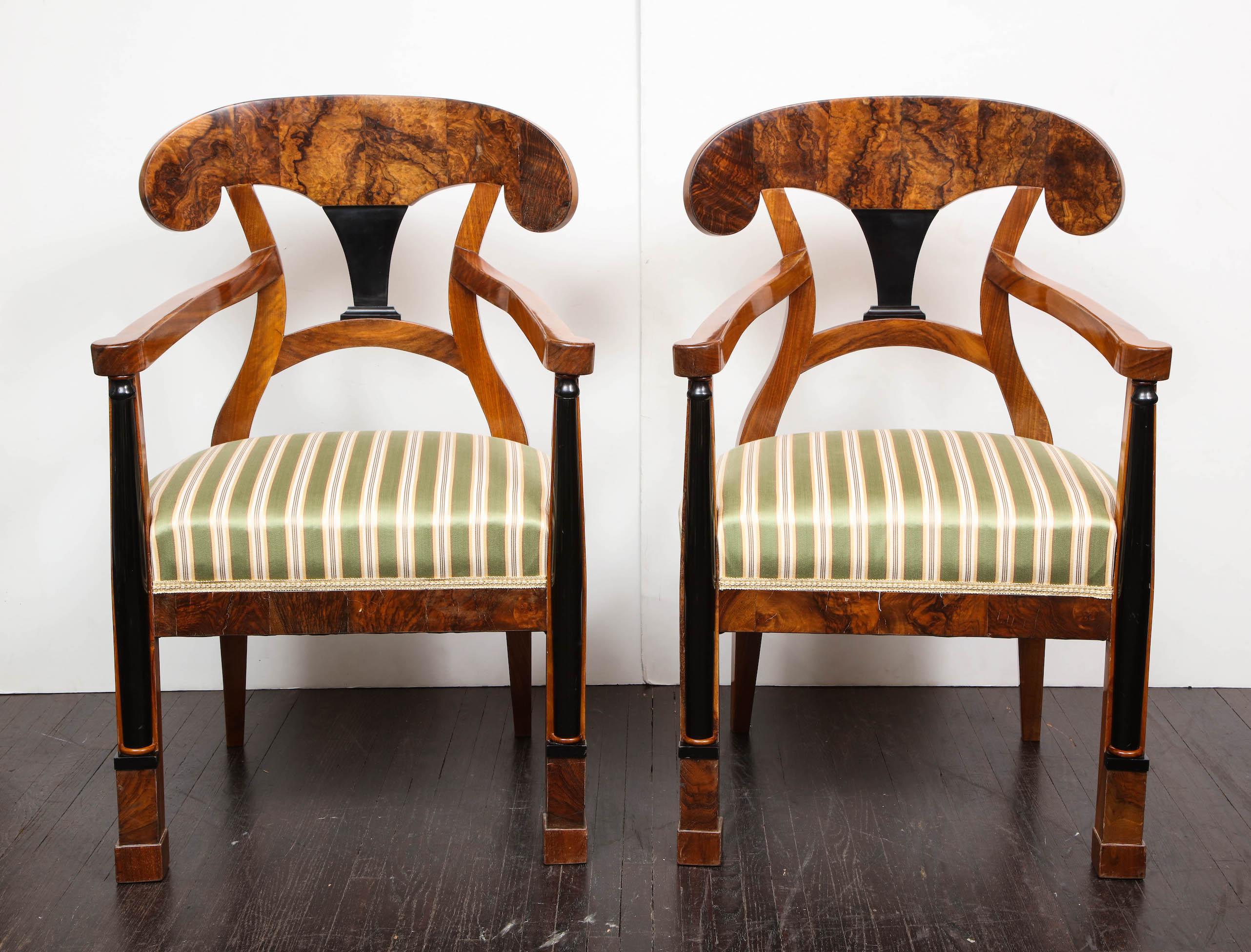 A pair of Swedish Biedermeier dining armchairs. The chairs are in good condition and show some fine scratches and minor cosmetic wear. Restoration and re-upholstery quote can be provided upon requests.