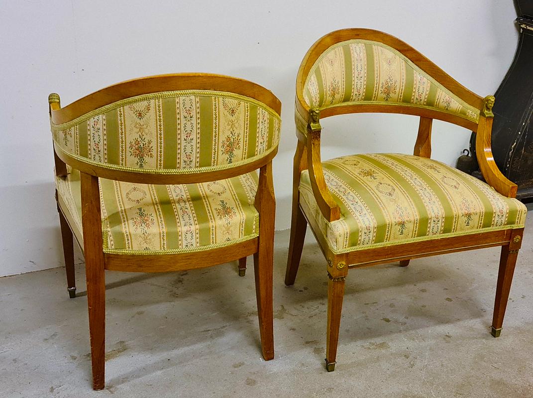 This is a rare pair of original Swedish Gustavian Biedermeier Barrel Back armchairs with golden birch veneers and inlaid marquetry in a rich honey color French polish finish and with unusual delicately fluted feet and brass detailing, C. early 20th