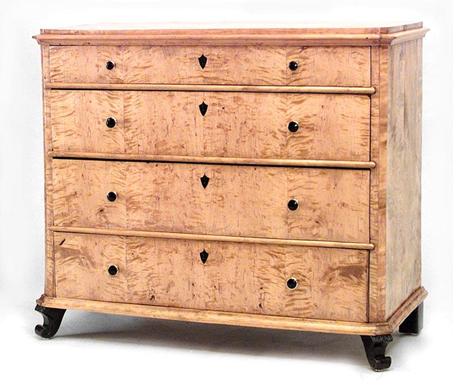 Swedish Biedermeier maple chest of four drawers with black trim on legs and inlaid medallion on drawers (19th century).
 