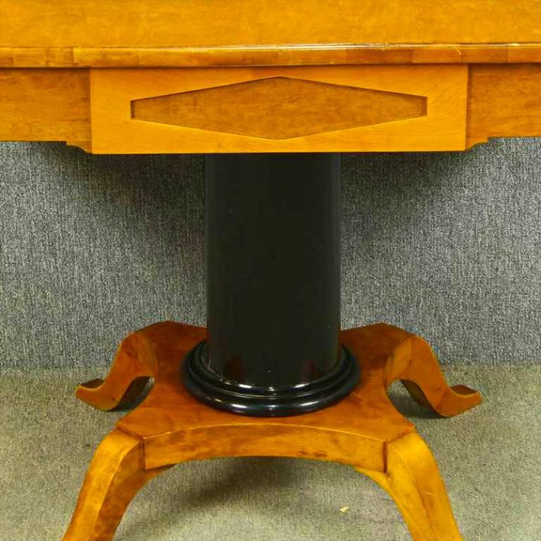 Unusual antique Swedish Biedermeier drop-leaf table in stunning quilted golden birch veneers with an ormolu style central column and four elegant curved feet.

There is a pretty inlaid design on the front panel and delicate detail on the bottom of