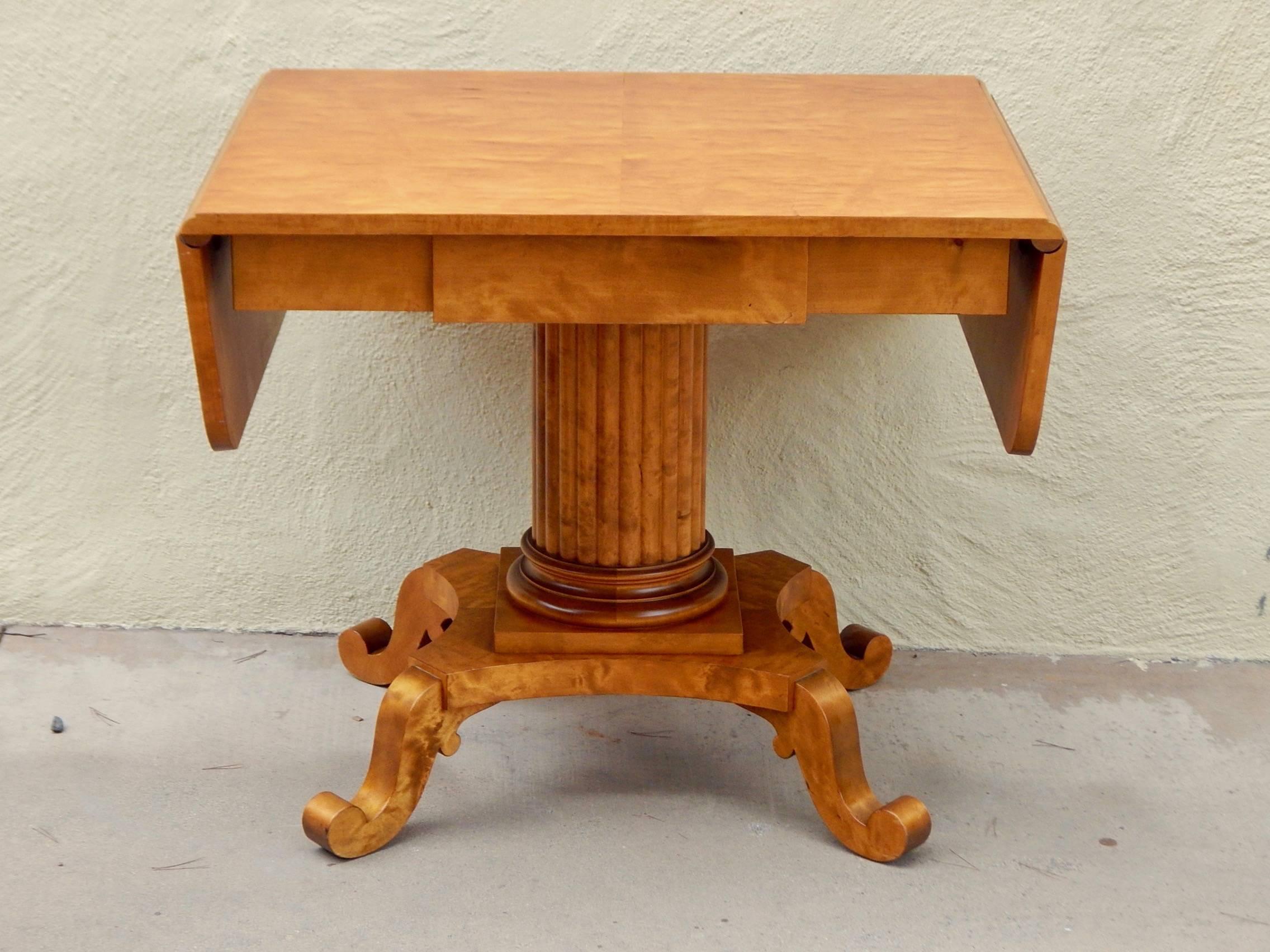 Swedish Biedermeier Revival drop leaf centre/side table rendered in highly figured golden flame birch wood. Stamped Johan Ekman, Malmö, Sweden on underside.
In excellent original condition with some wear and surface scratches. See photos for more