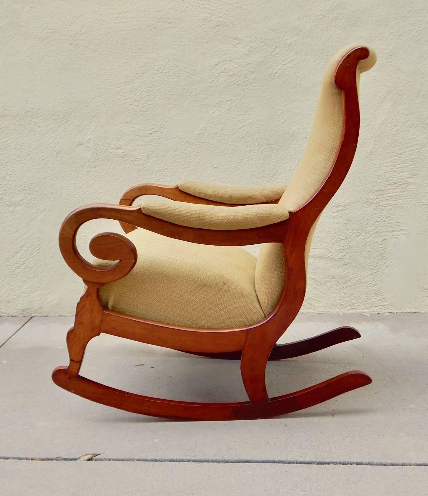 Swedish period Biedermeier rocking chair rendered in birch wood. In original fabric. In excellent structural condition. Wood has had some repairs, Sweden, circa 1850.