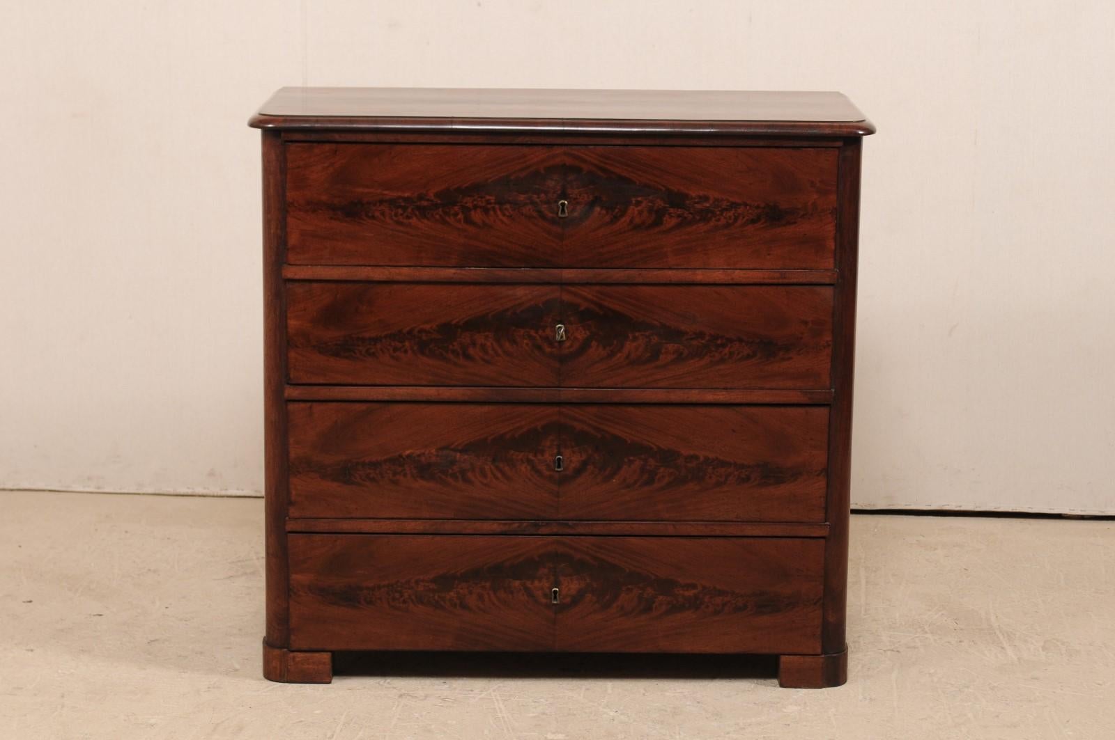 A Swedish mahogany secretary chest from the 1830s. This antique Swedish Biedermeier case piece has the appearance of being a four drawer chest at first glance. However, upon closer inspection, the upper 