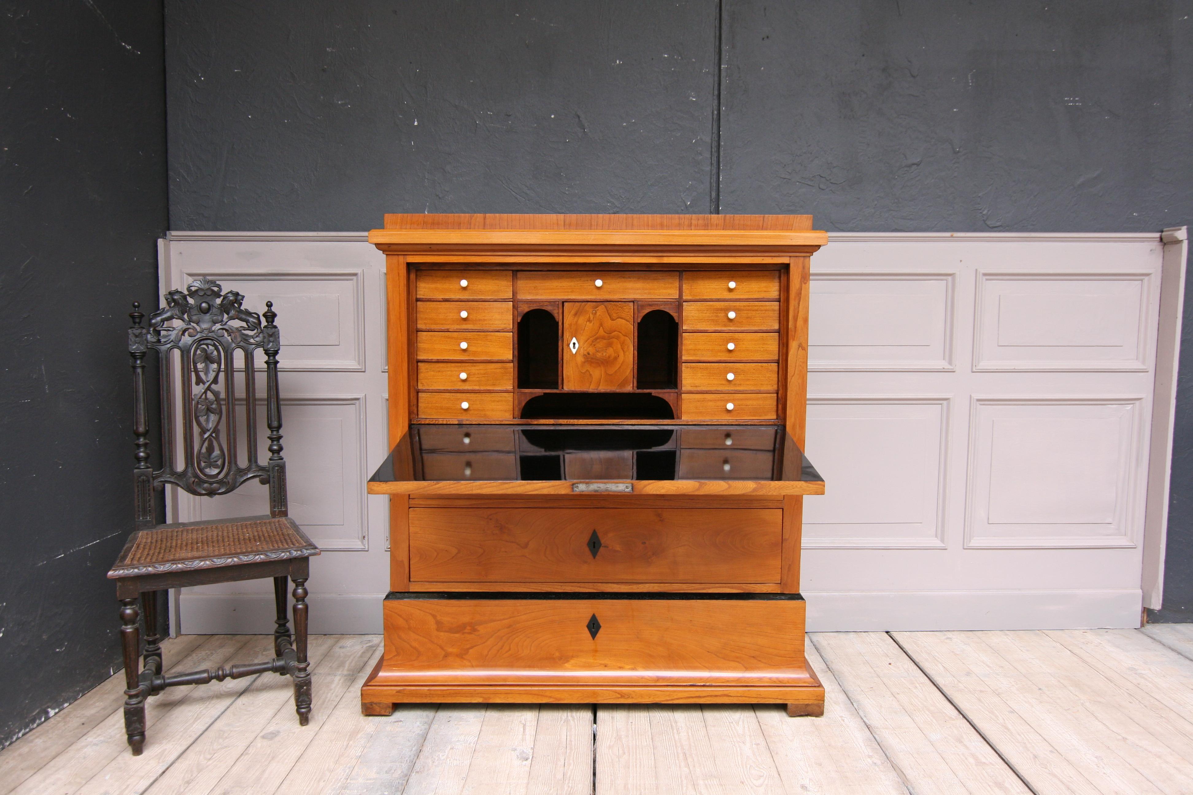 Original Biedermeier secretary from Sweden, circa 1830-1840. Cherrywood veneer. Expertly hand-polished with shellac (French polish).

Half-high body, consisting of the expansive base with a large drawer, and sitting on it the main part with 2