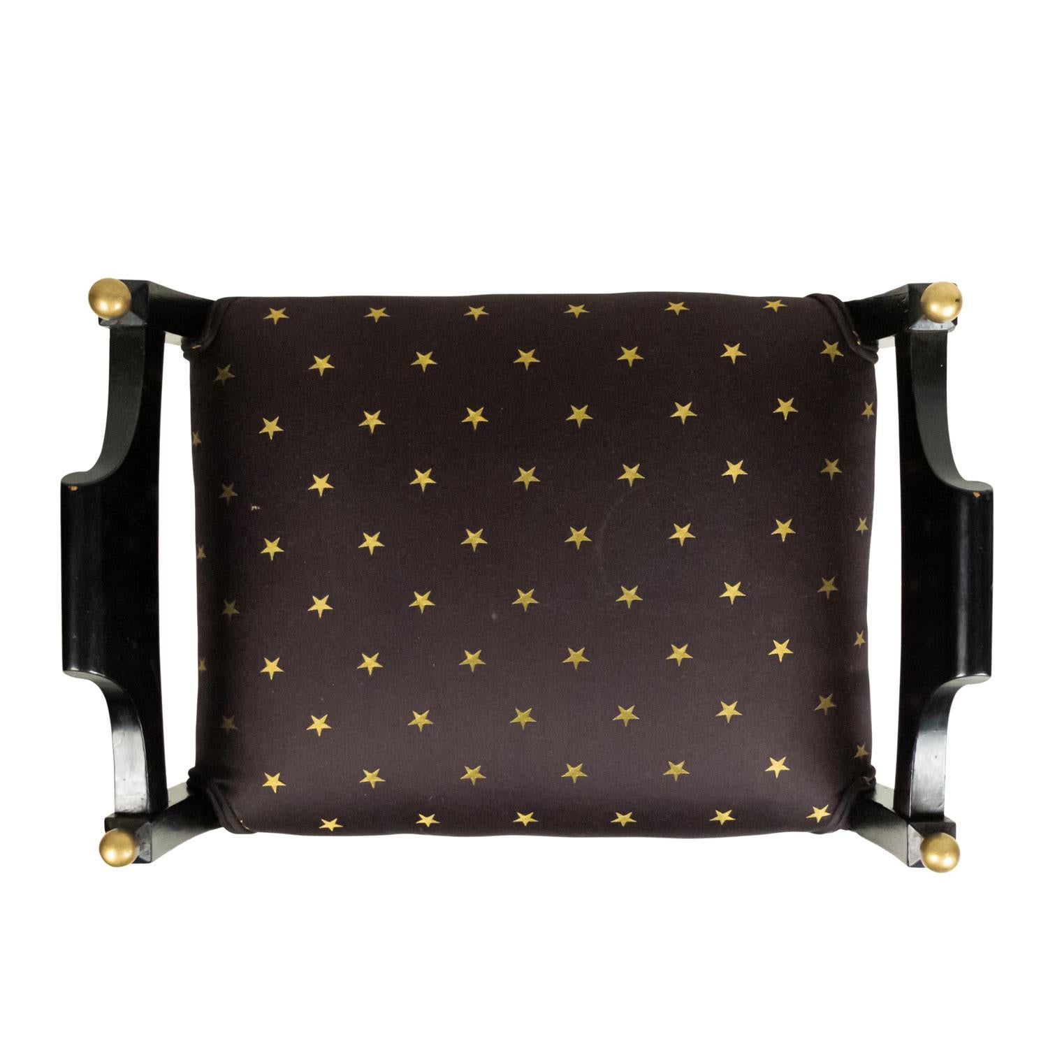 Swedish Biedermeier style (20th Century) black lacquered bench with side arms and black upholstered seat with gold star design.

Condition consistent with the age of piece