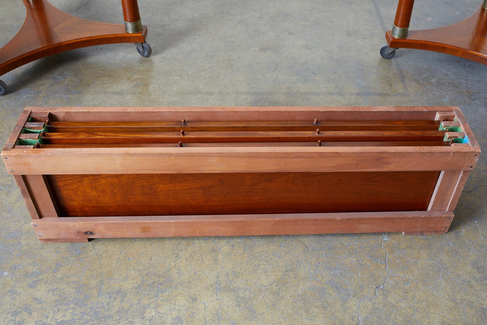 Splendid mahogany library table or dining table featuring an expanding oval top. Made in the Swedish Biedermeier taste with a more restrained style. The large oval top has a thin reeded edge and is supported by two columned bases each having three