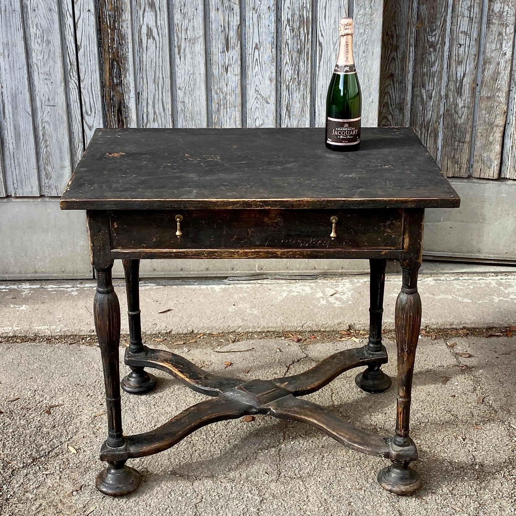 19th Century Gustavian style black painted Table. The rectangular table has 1 drawer with tear drop shaped brass hardware. This charming table would be well suited as a side table or in an entrance.