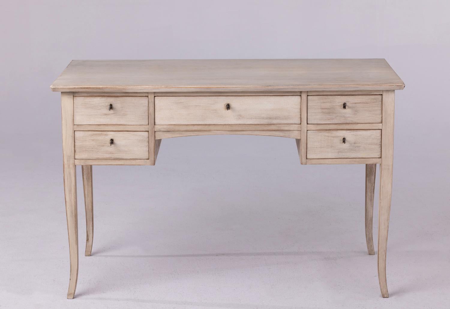 A Swedish writing desk from the 1920's that has been bleached and lime washed creating a beautiful patina. Plenty of storage with 4 deep drawers on the sides and 1 long center drawer. The apron height/knee clearance is 23.63 inches H. The side